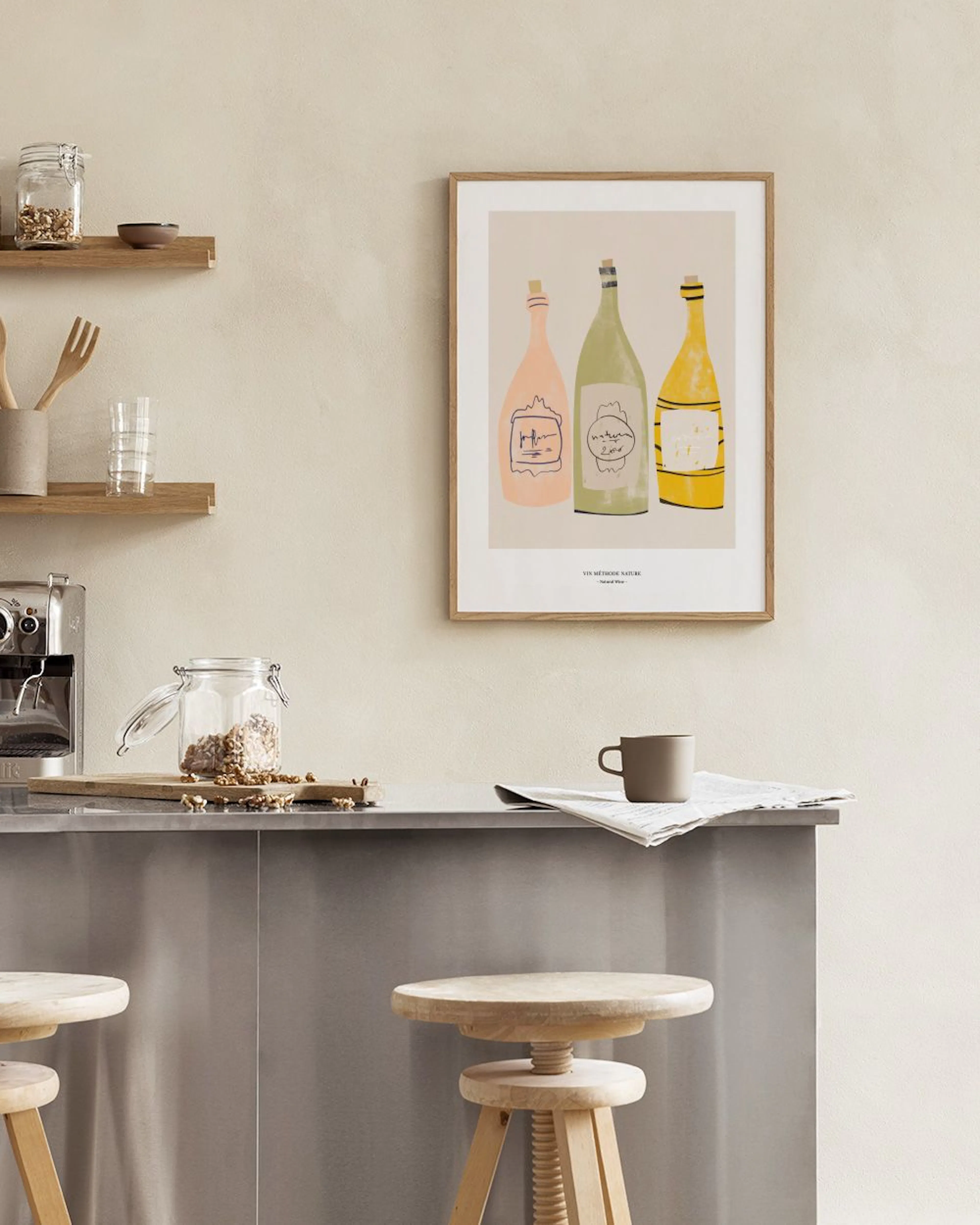 A print of three wine bottles in peach, light green, and yellow, with corks and labels, displayed above a white cabinet with a v
