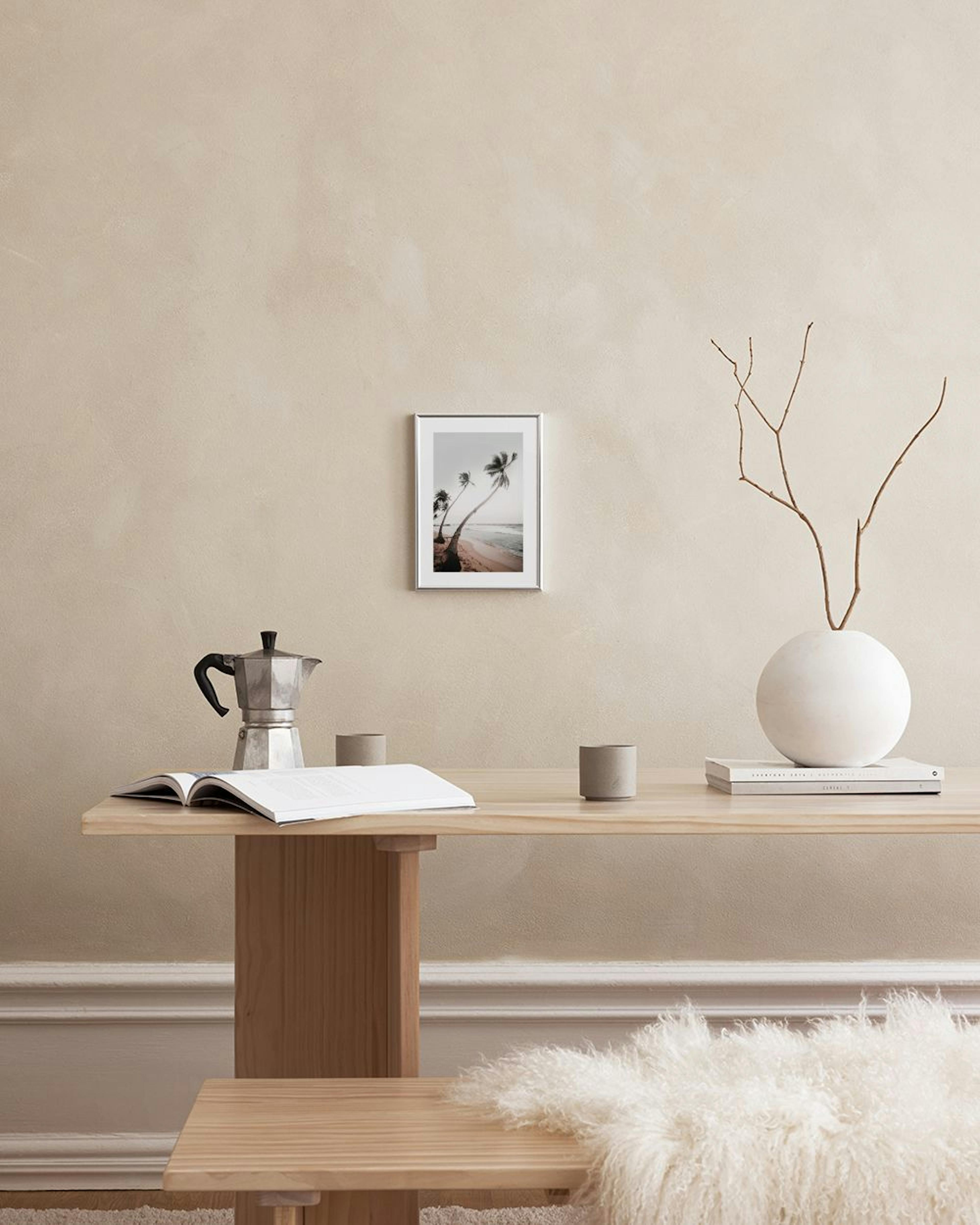 A gallery wall of beach and surf prints, with an Adventure Awaits print, hanging in a living room above a blue armchair.