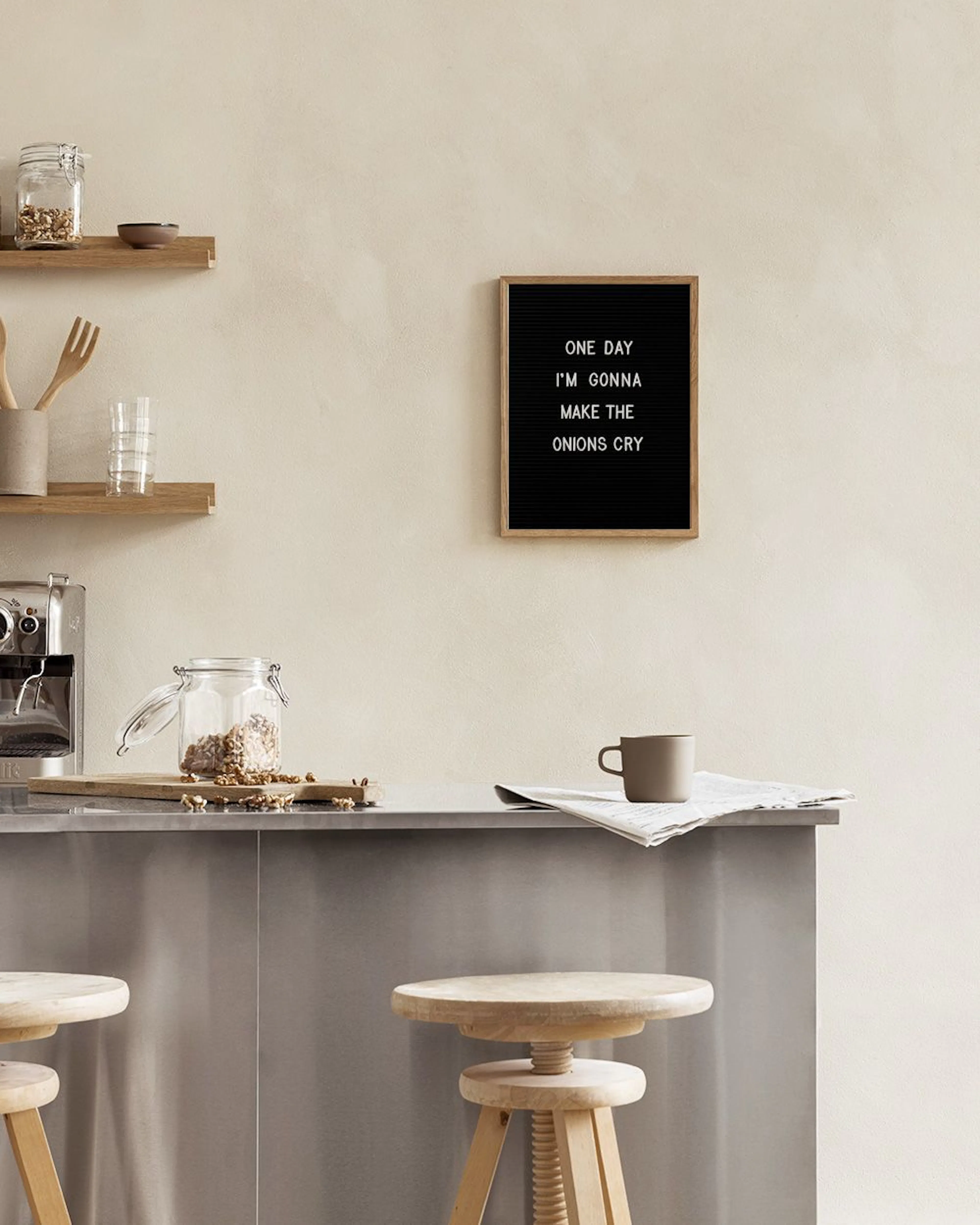 A black letter board print with white letters spelling out ONE IM MAKI.