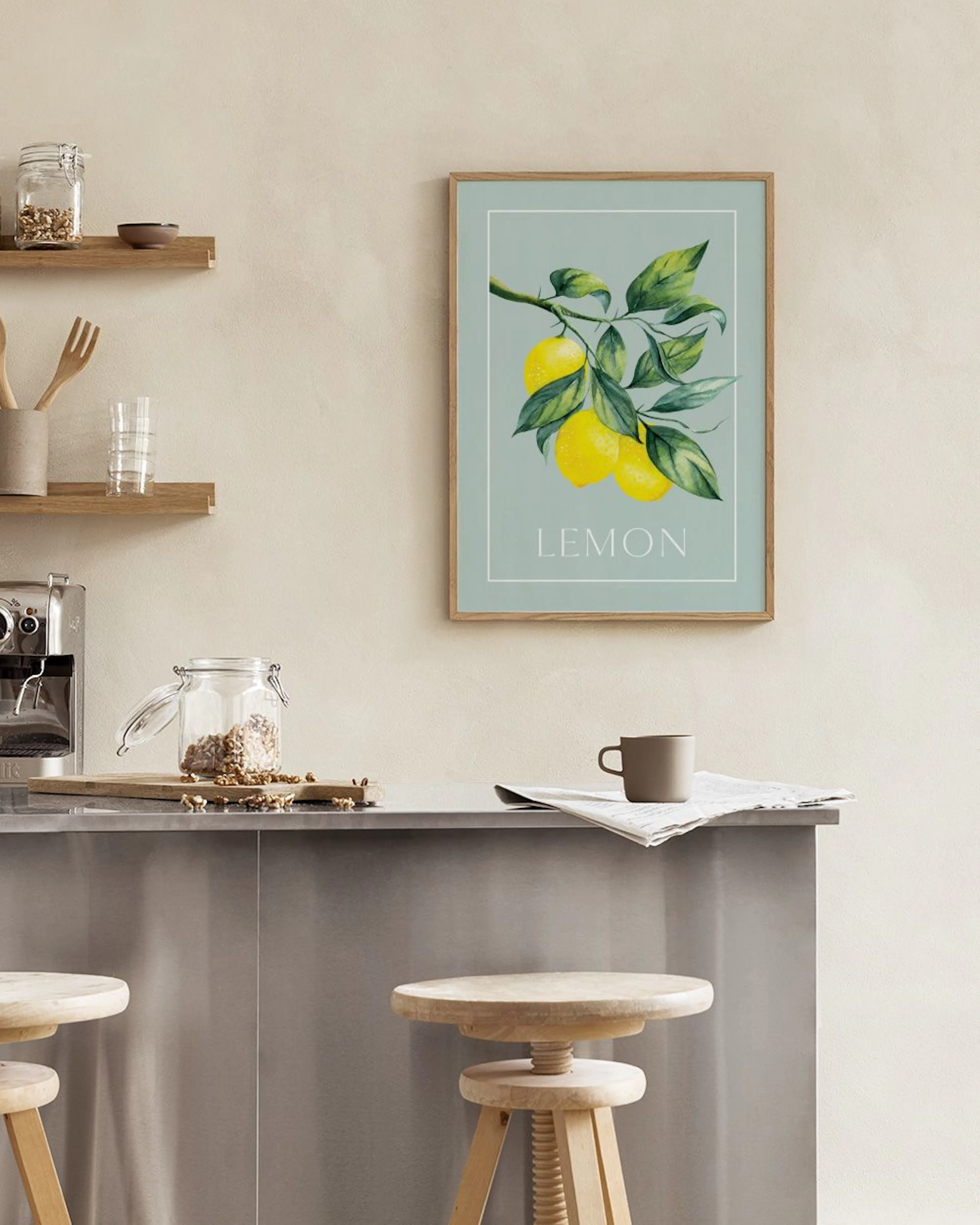 A print of yellow lemons and green leaves on a branch, displayed on a light blue background, hanging above a table with a white 