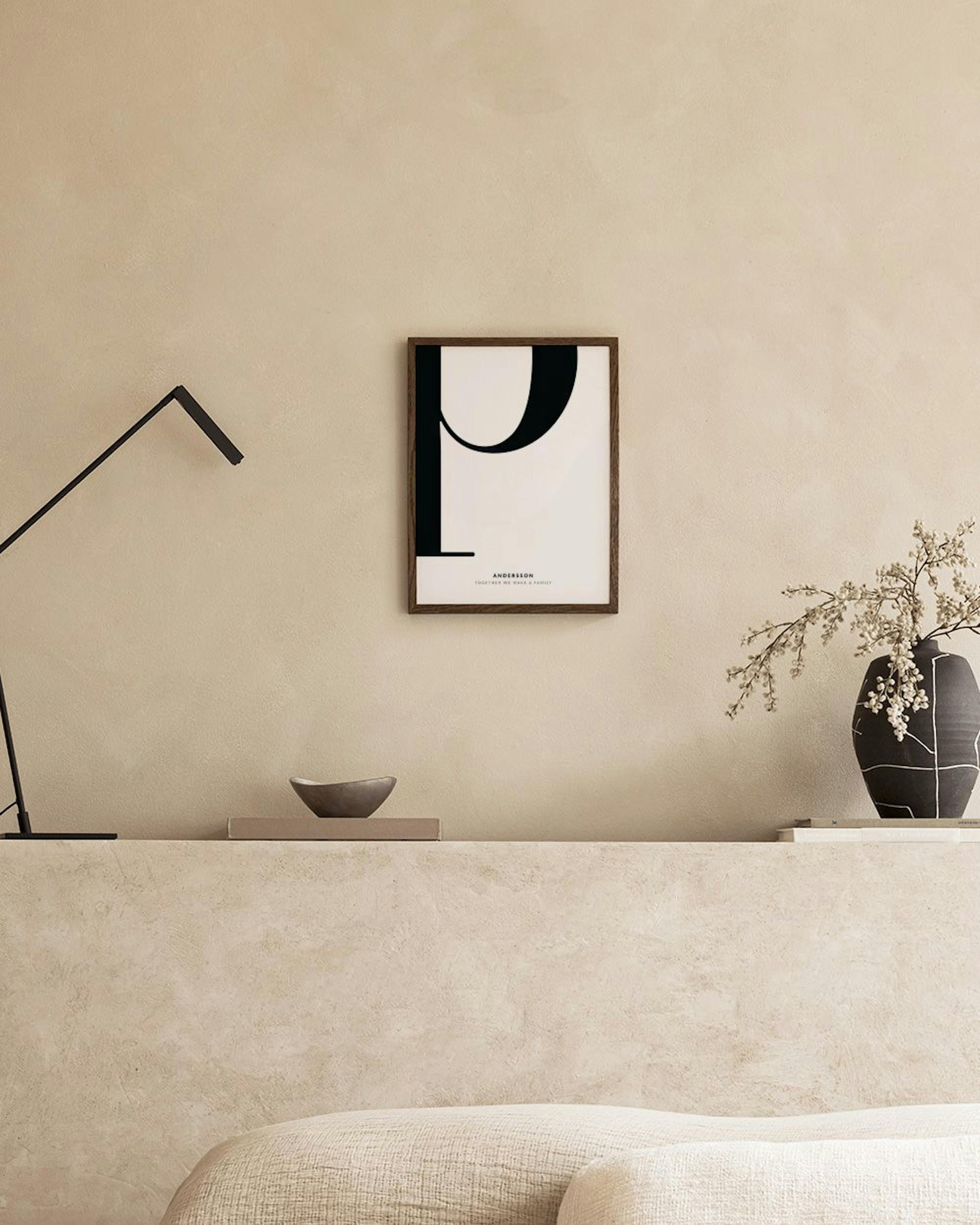 A personalized print with a large black letter P and family name, displayed above a woven cabinet.