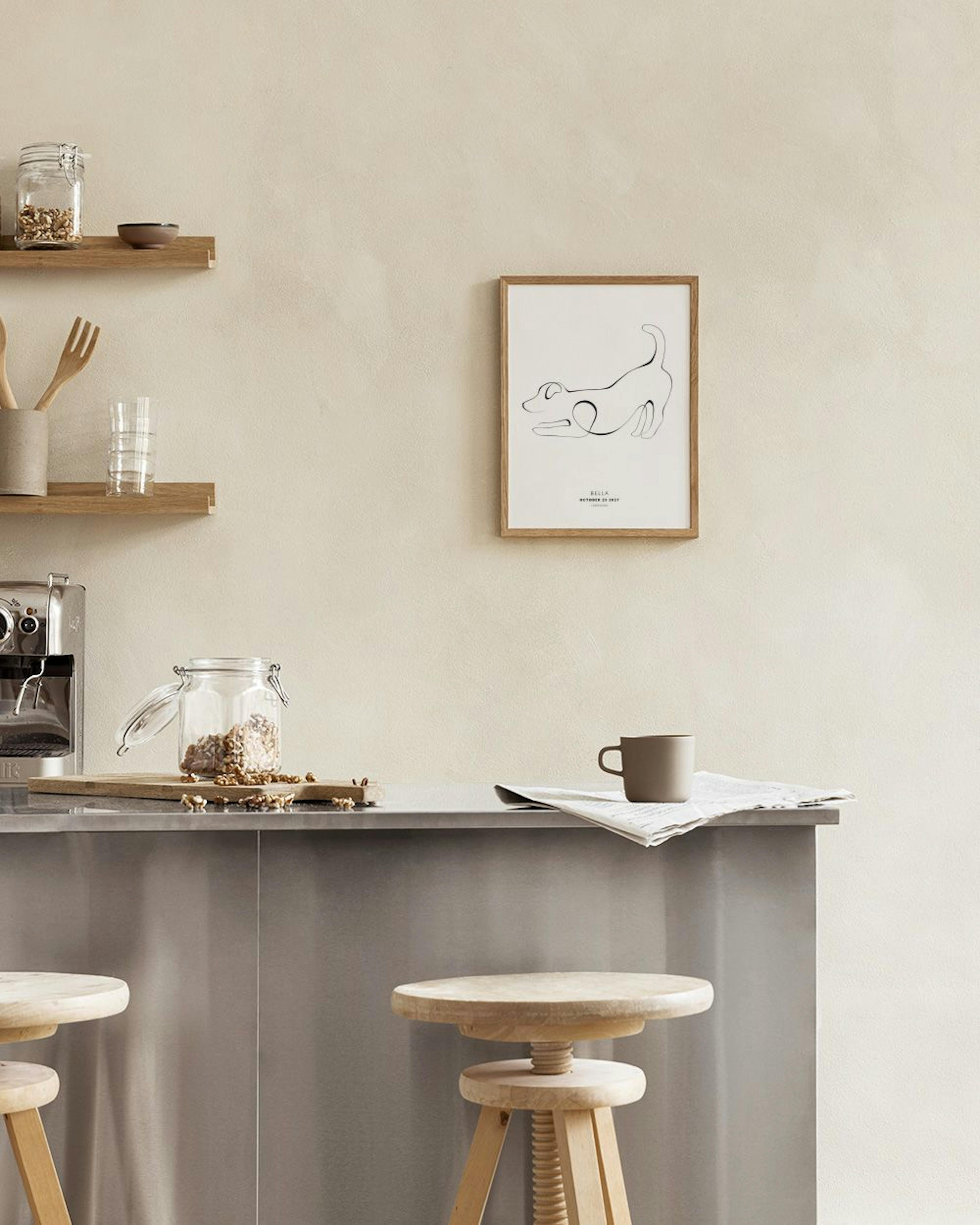 A personalized print with a continuous line art drawing of a dog, hanging above a natural wood console table.
