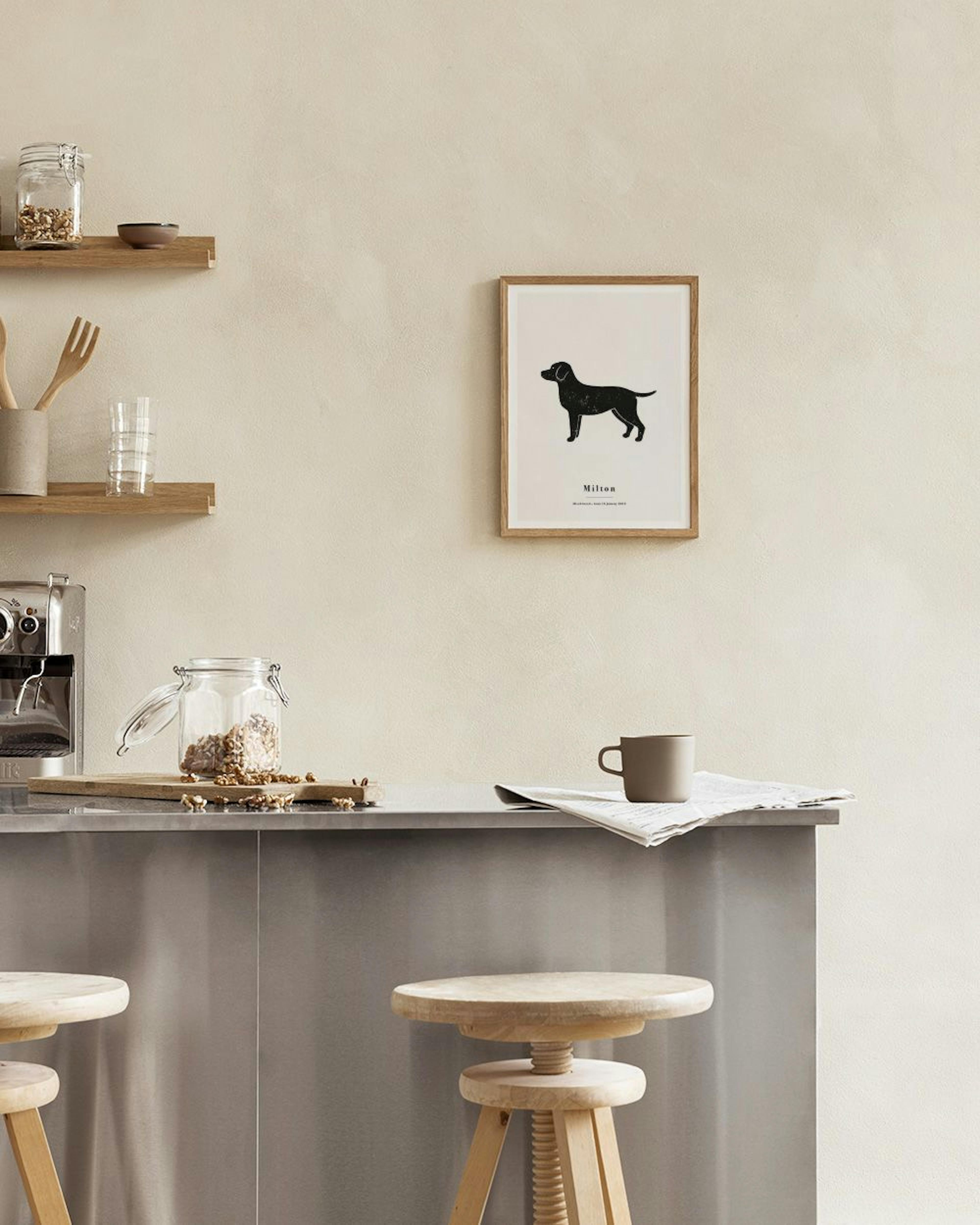 Personalised print of a black dog silhouette, named Milton, displayed above a brown cabinet with books and decor.