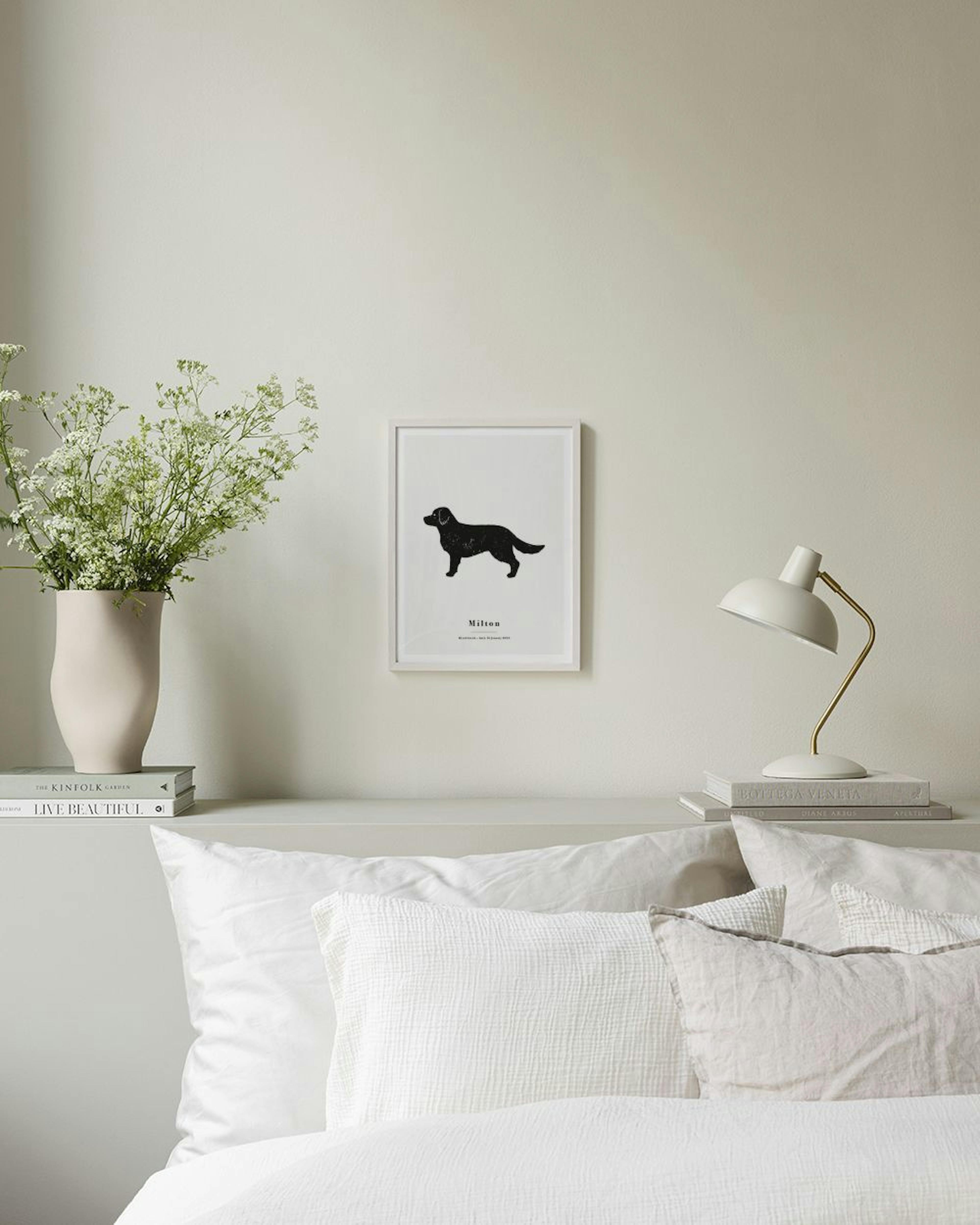 Personalised print with a black dog silhouette and text Milton above a dark grey cabinet with a white lamp and decorative wooden