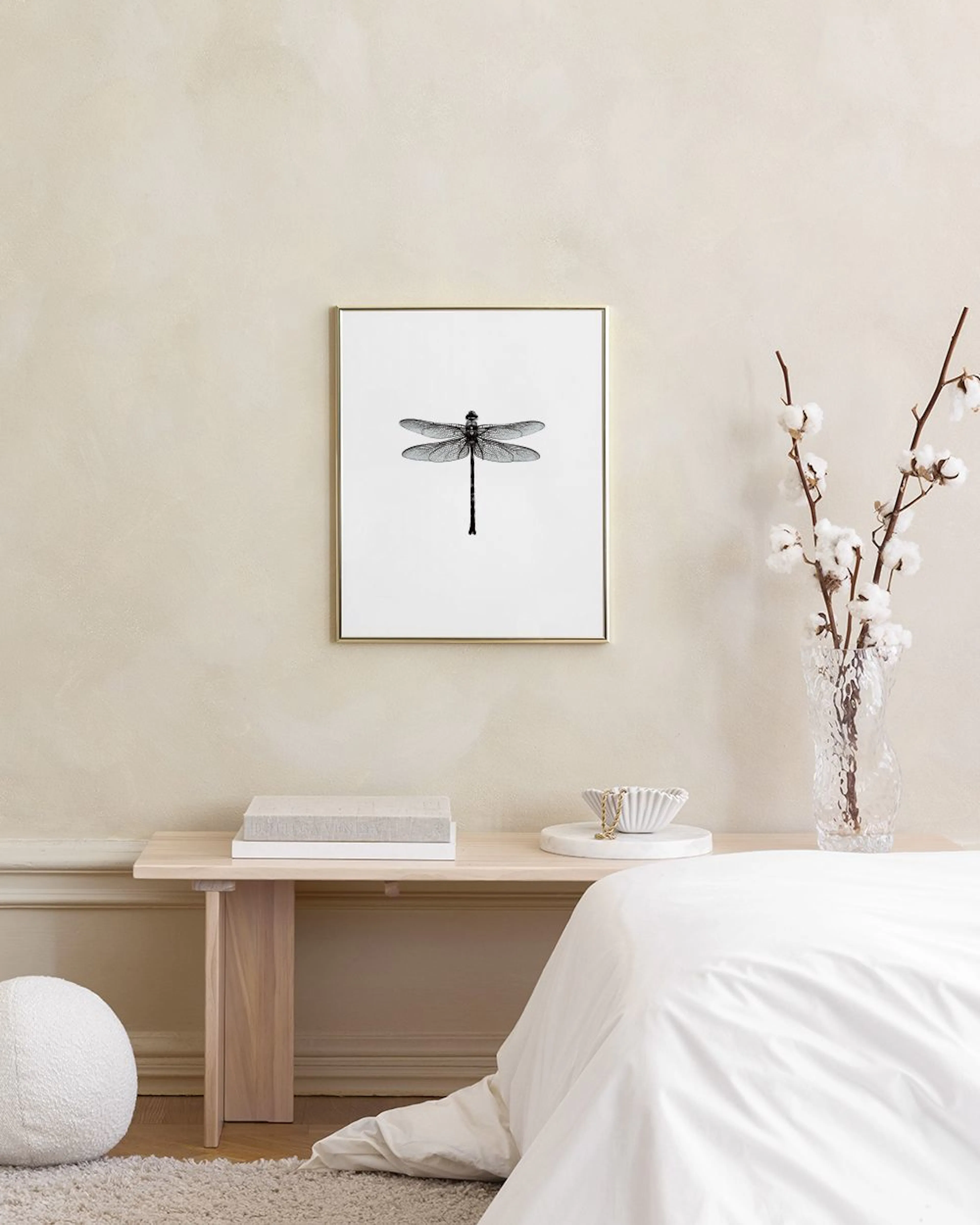 A gallery wall of black and white prints, including an ampersand, a dragonfly, a diamond, a womans face with dramatic lips, and 