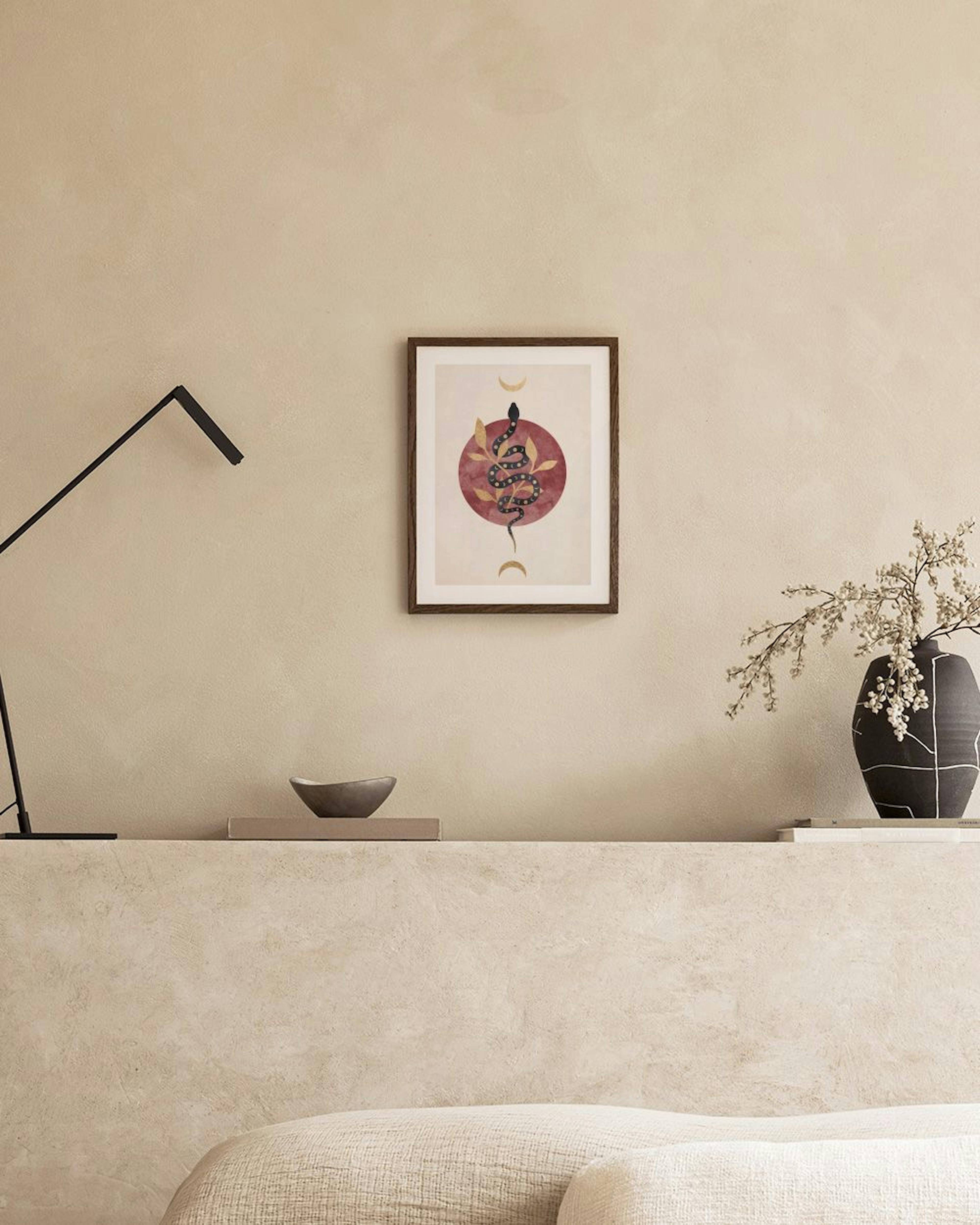 Mystical print with a black snake wrapped around gold leaves on a red circle, flanked by crescent moons, hanging above a chair.