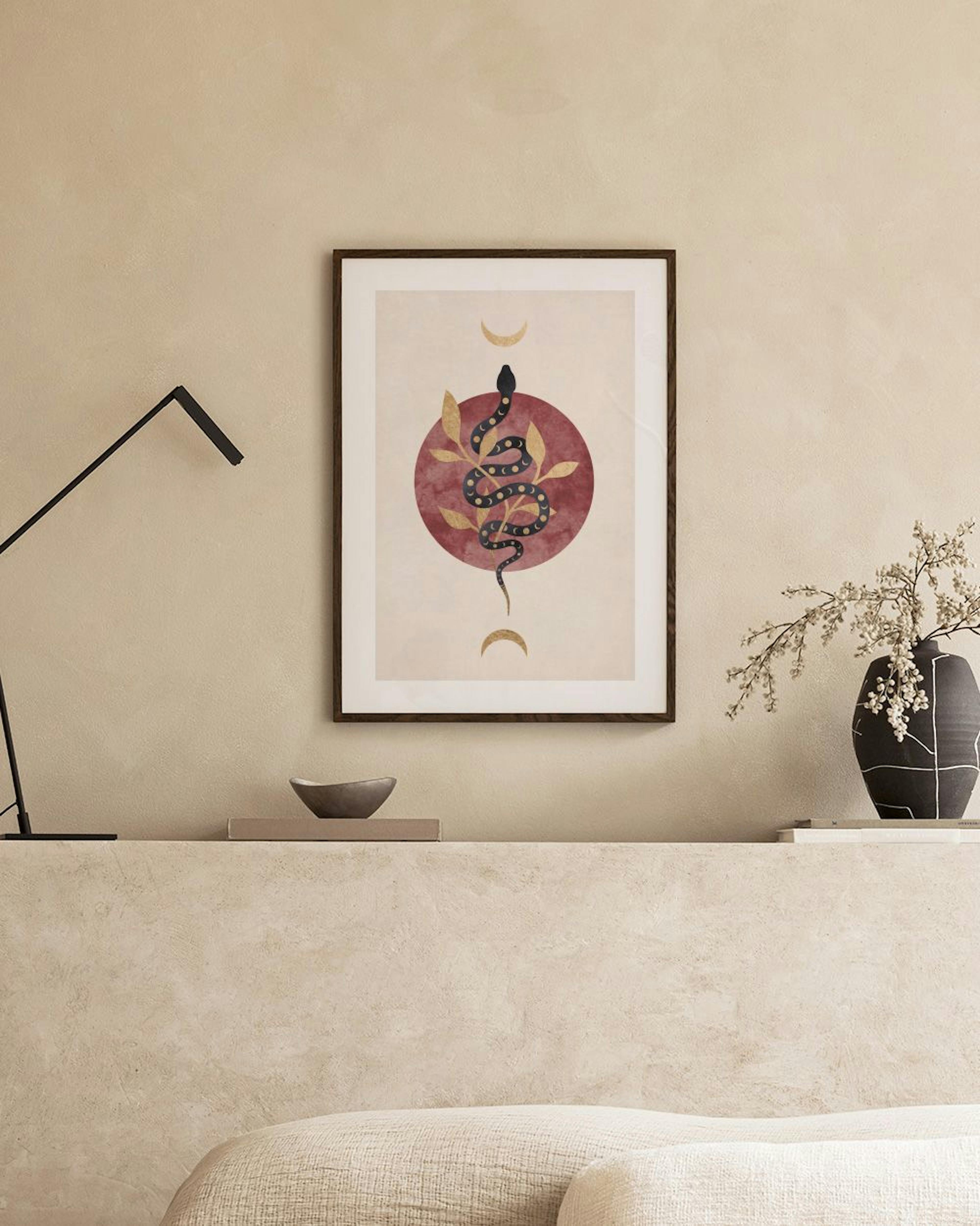 A print of a black snake with gold accents wrapped around a red circle and gold leaves, hanging in a light-colored room with a b