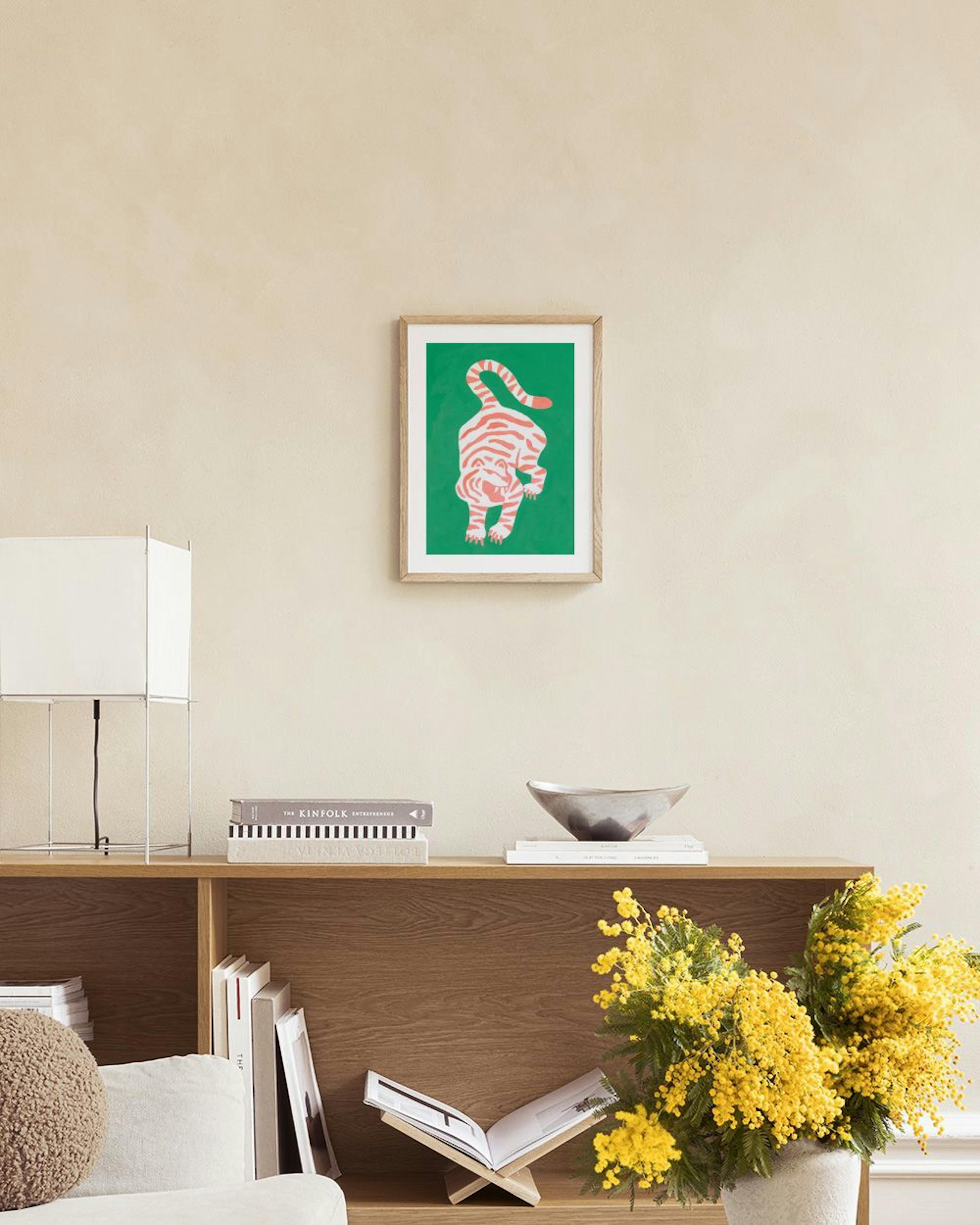 A colorful tiger print with red stripes on a green background, hanging above a green armchair in a living room.