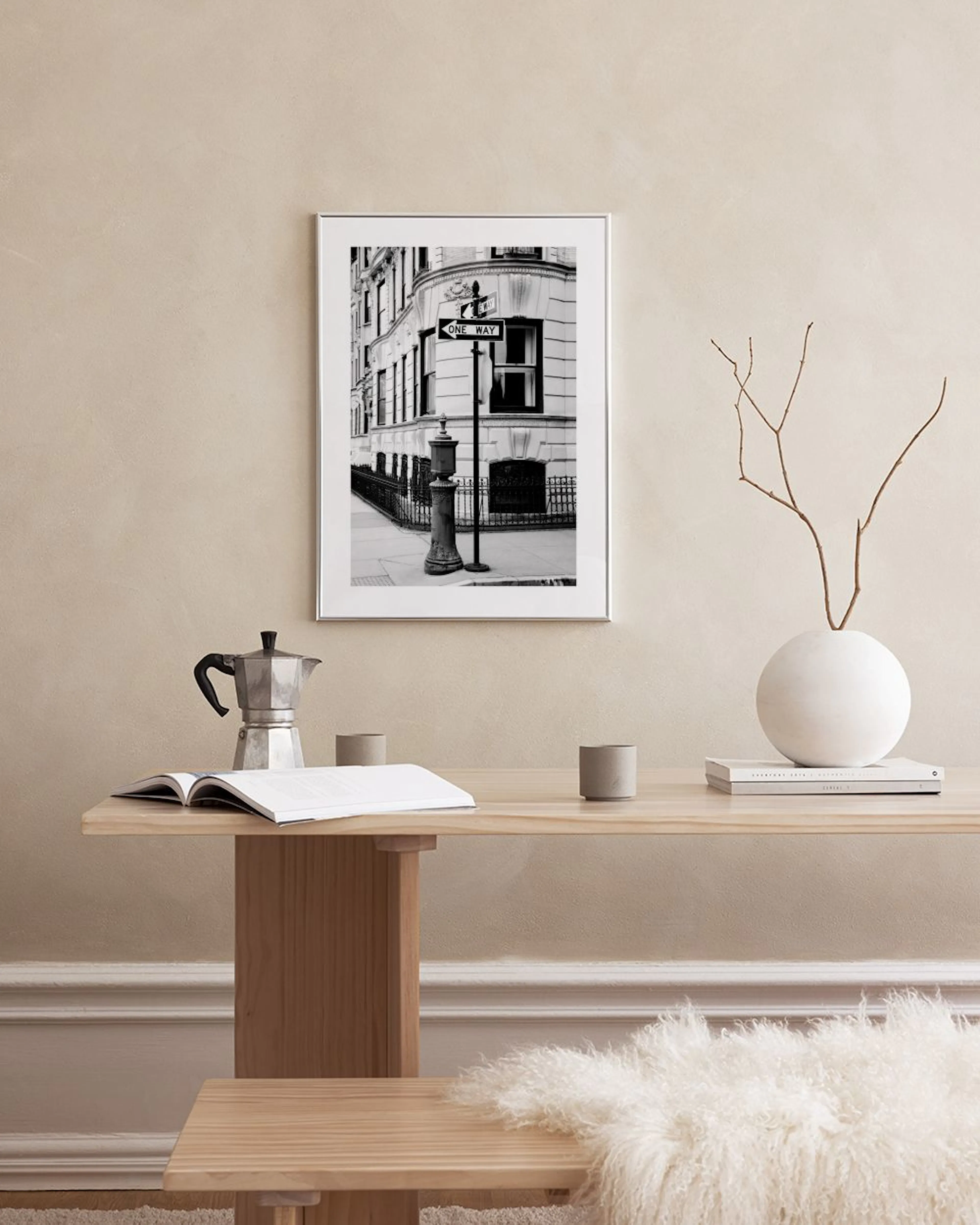 Schwarz-weiß Poster eines New Yorker Gebäudes mit Einbahnstraßenschild, auf einer Kommode in einem modernen Raum.