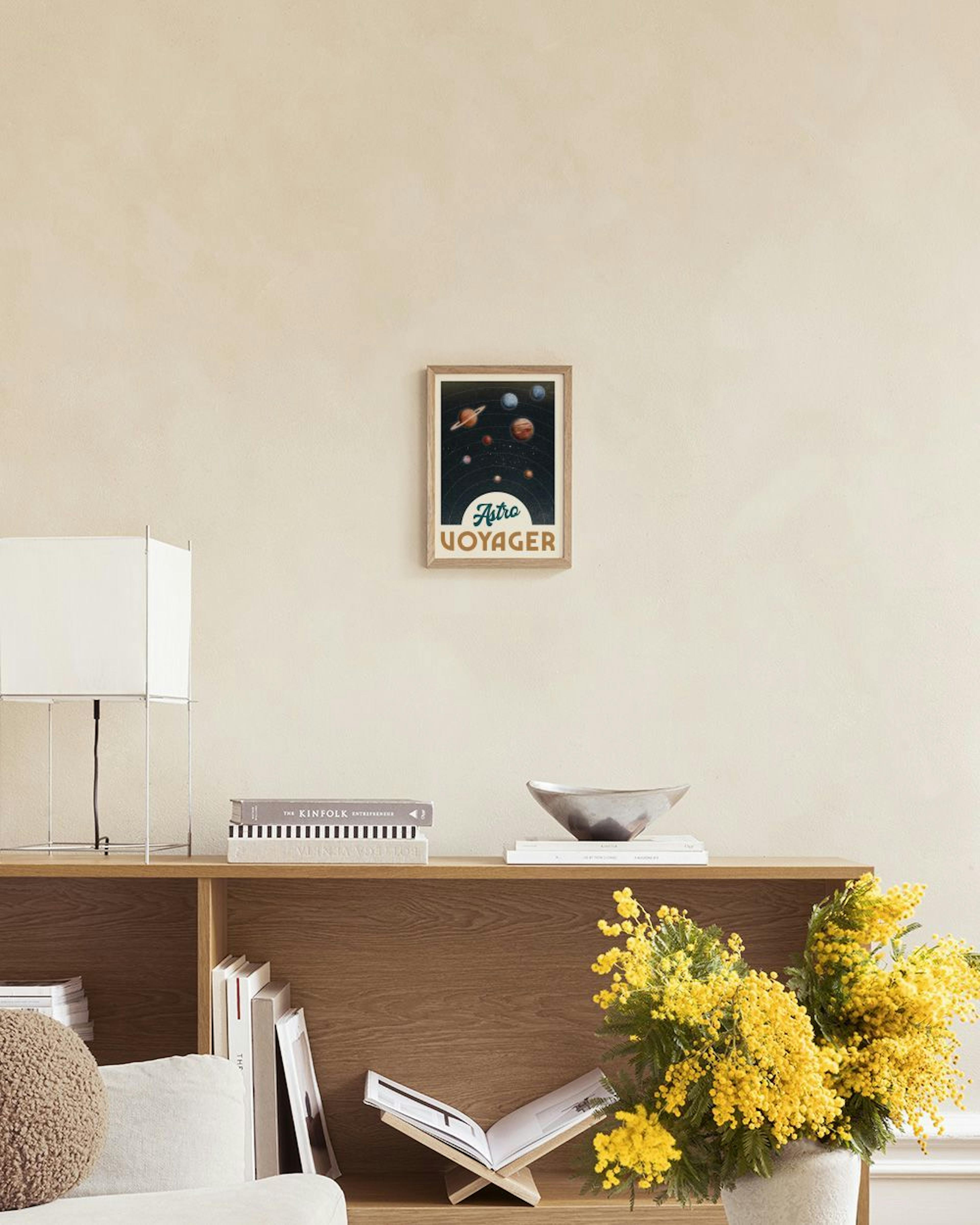 Poster Astro Voyager mit Planeten und Himmelskörpern im Weltall, hängt über einem Beistelltisch mit Lampe.