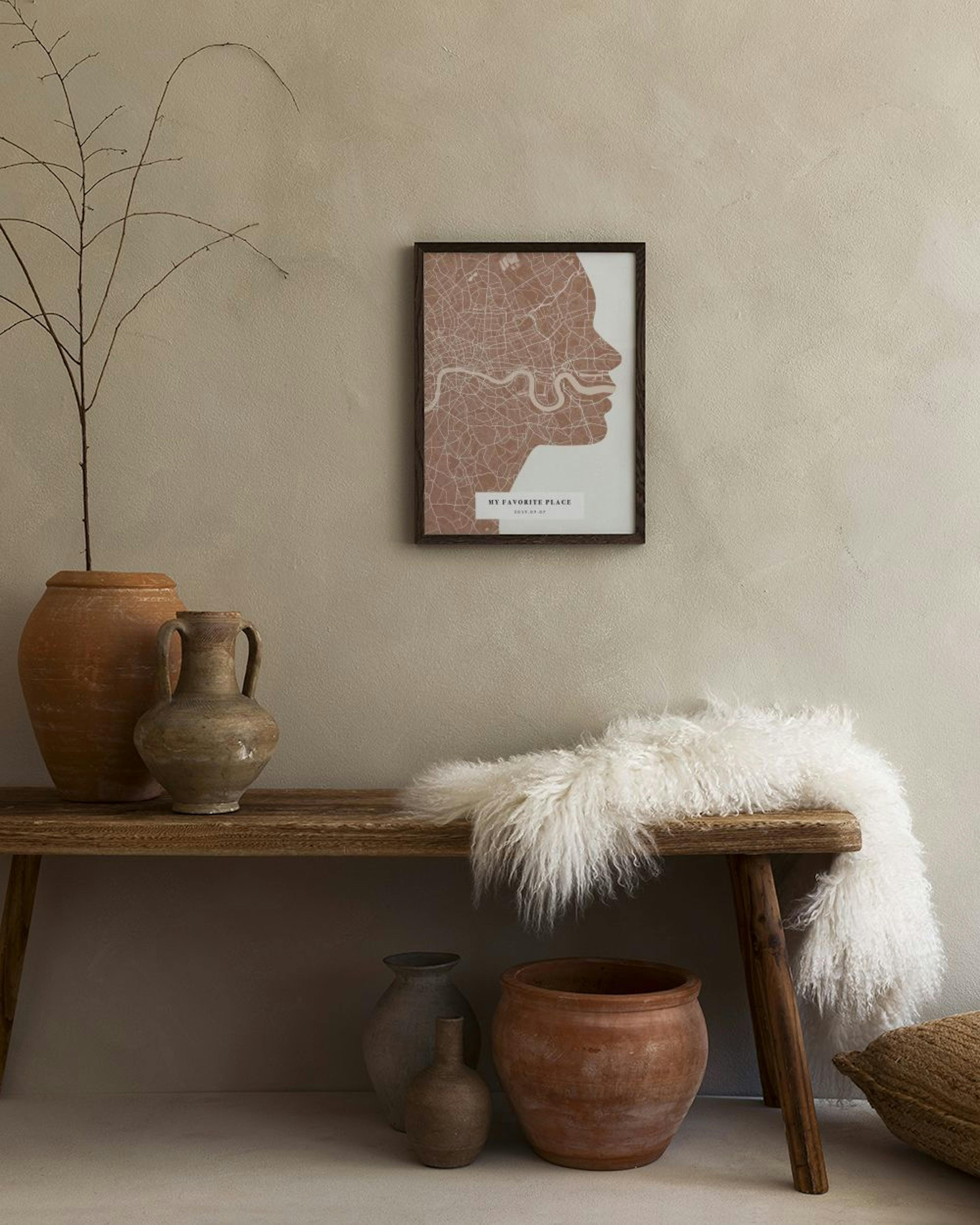 Personlig plakat med et kart over London formet som en profil av et ansikt, henger over et lite sidebord i et moderne rom.