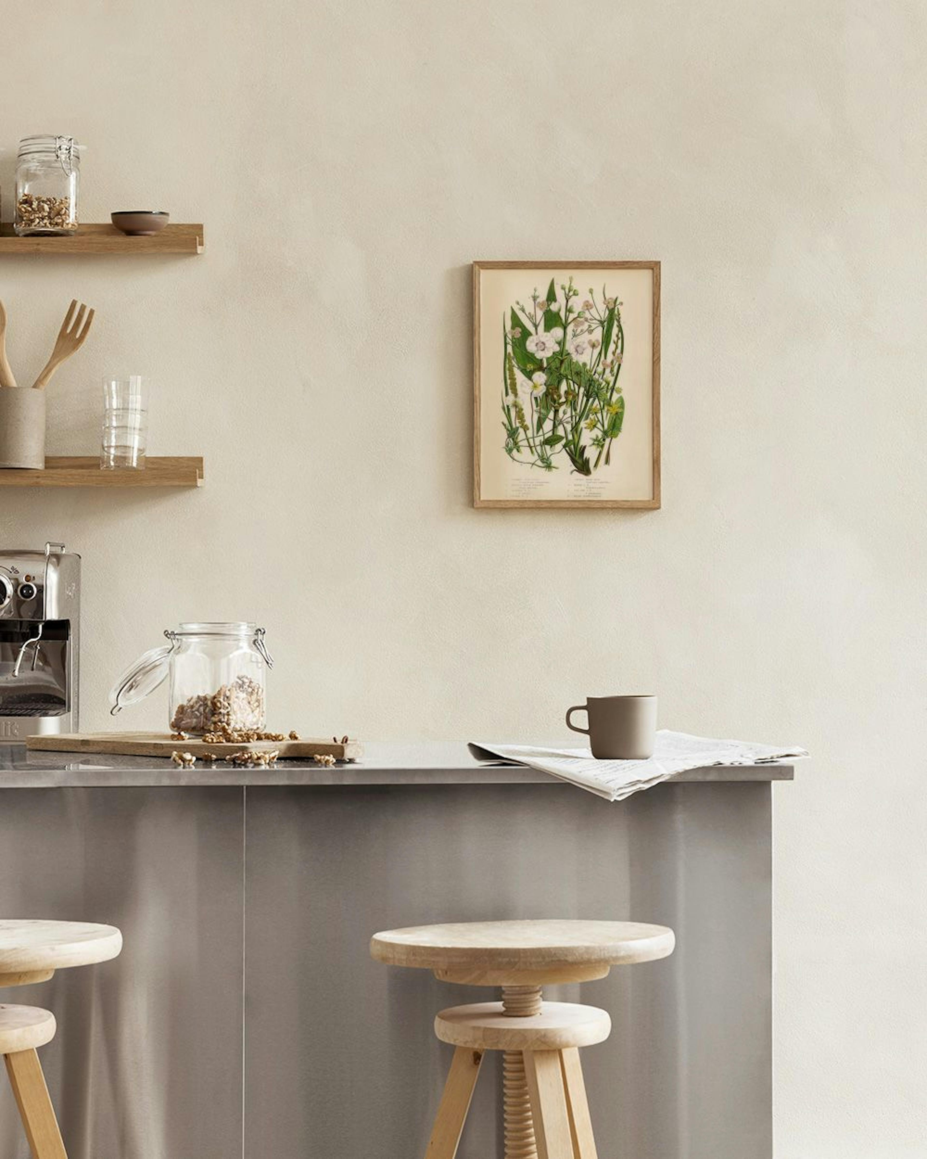 Botanical print of white, pink, and yellow flowers with green leaves, hanging above a wooden shelf with a plant and decor.