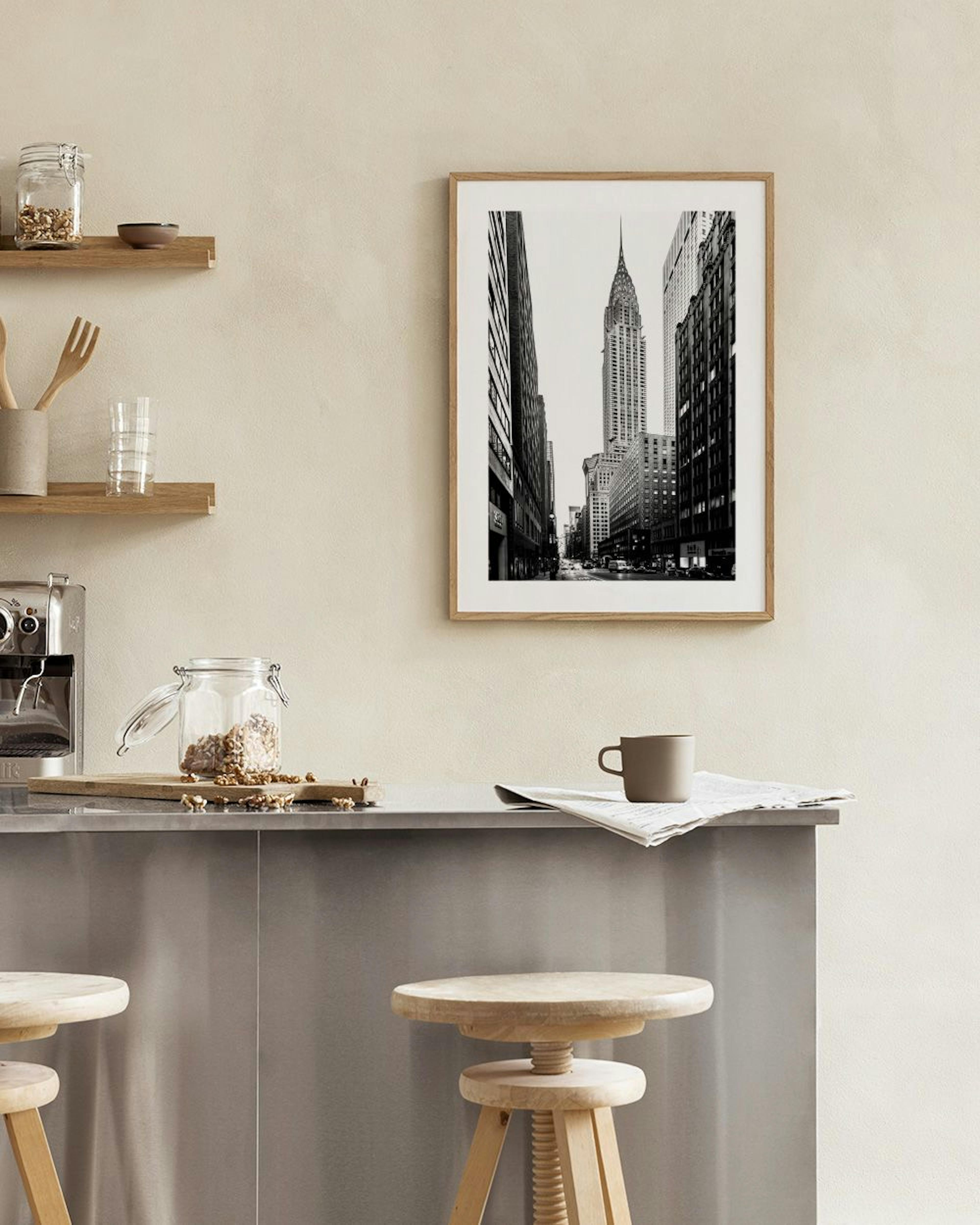 Black and white print of the Chrysler Building in New York City, displayed on a wooden bench with decorative objects.