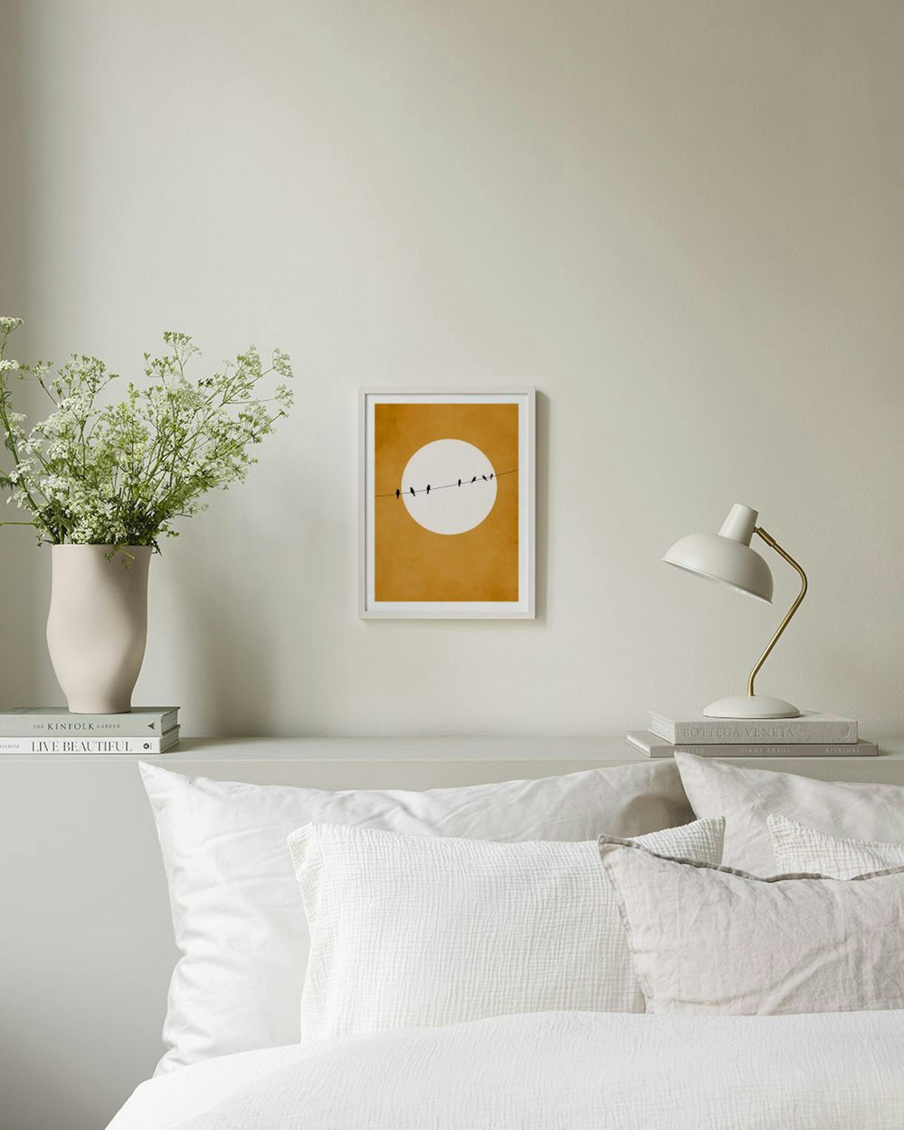 A print of black birds on a wire against a white circle and mustard yellow background, hanging in a modern room above a blue ott