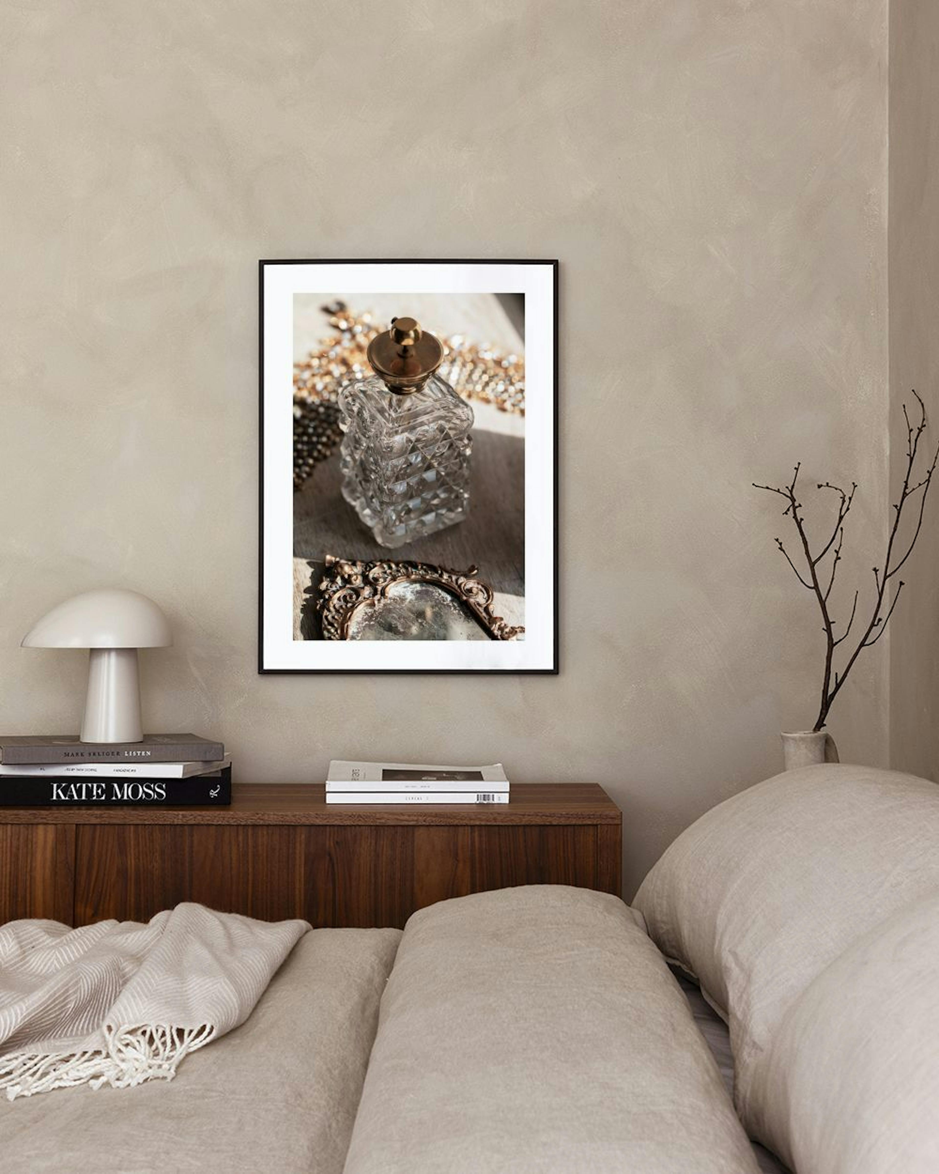 A print of a vintage perfume bottle and ornate mirror on a marble stand, set against drapes and a fluffy rug.