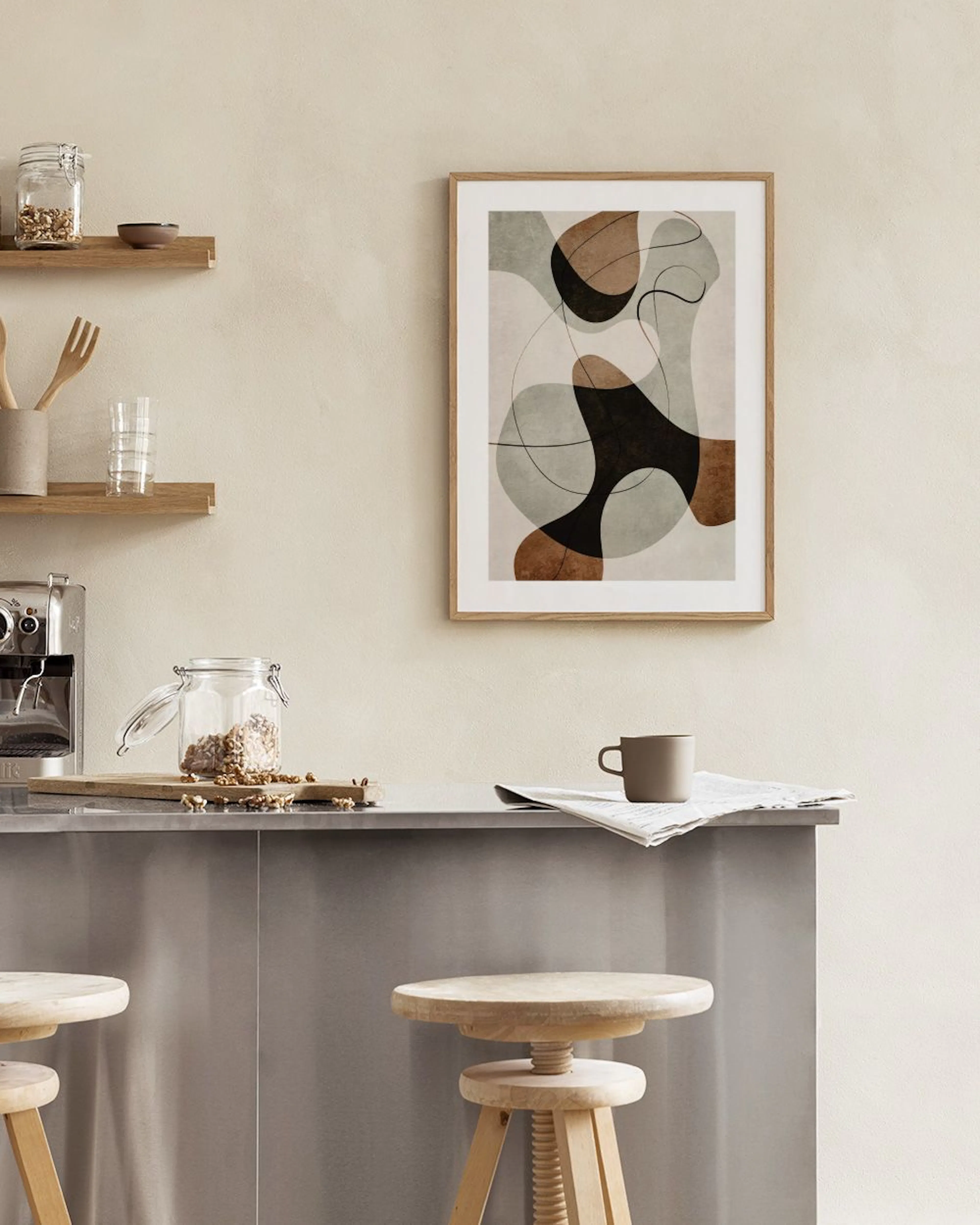 Abstract print with black, brown, and grey organic shapes, and thin black lines on a light background, displayed above a wooden 