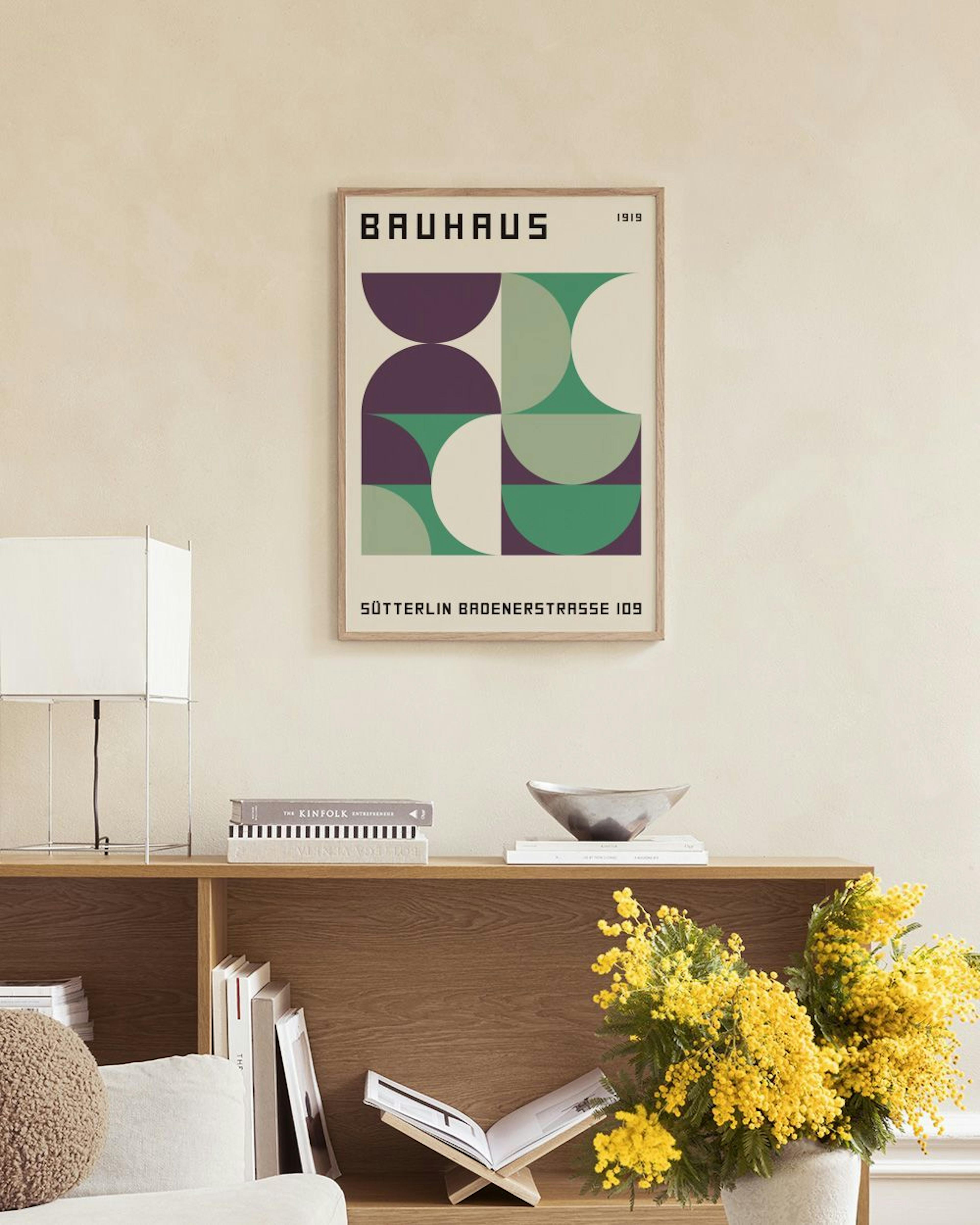 Bauhaus geometric print with purple, green, and white semicircles, displayed on a concrete bench with decorative spheres and a l