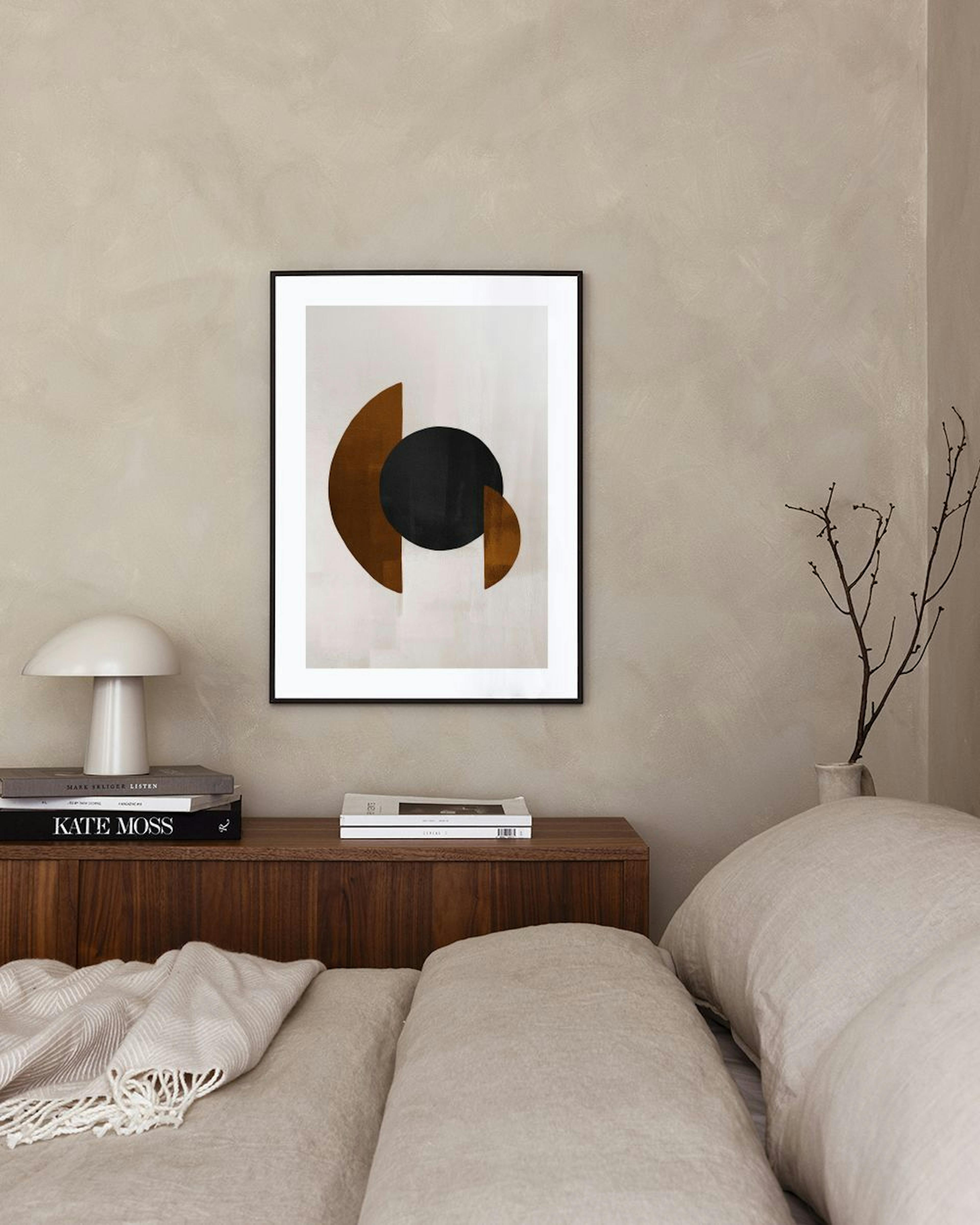 Poster con forme geometriche astratte nere e marroni, appeso in un moderno soggiorno con poltrona e cactus.