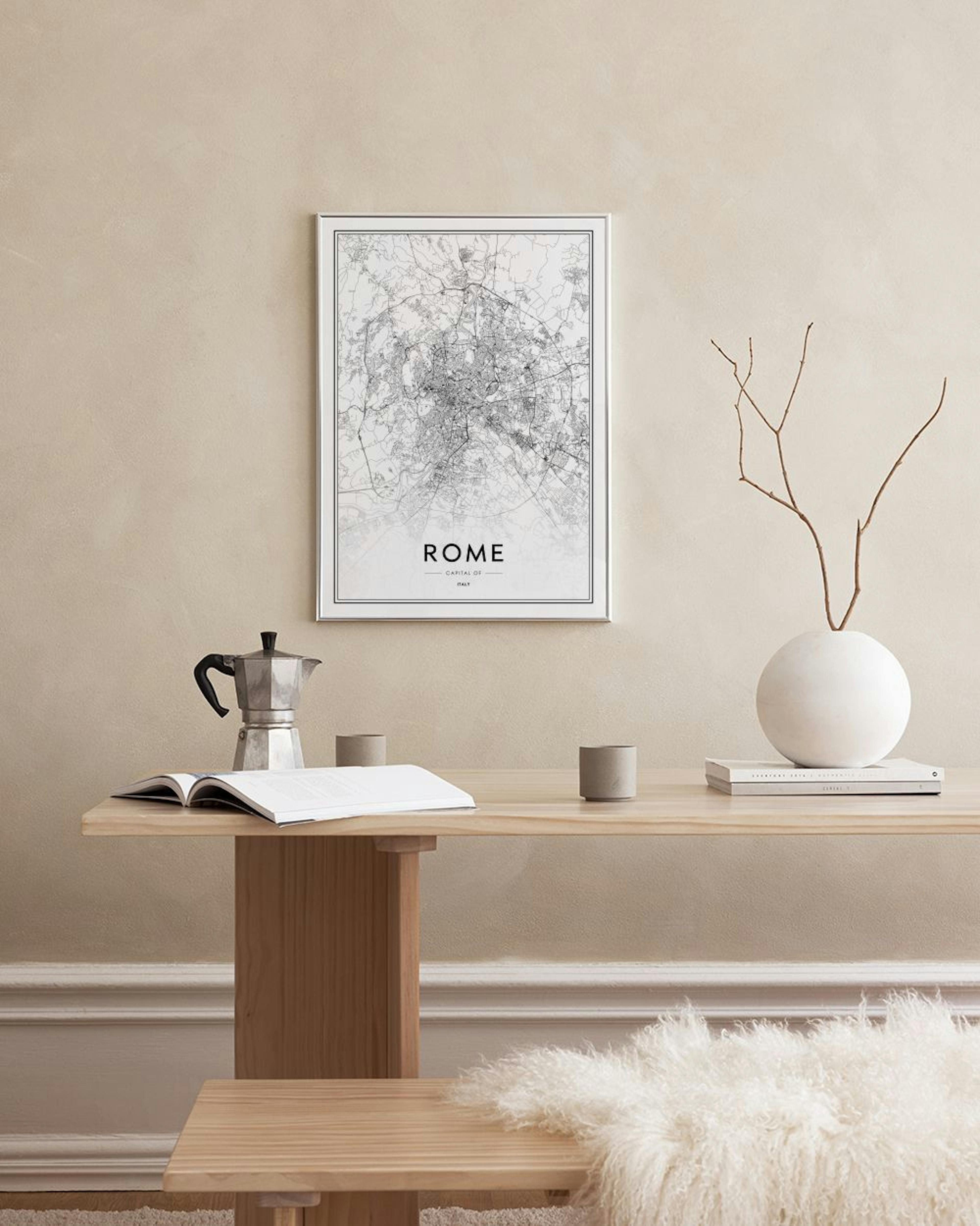 A Rome city map print in black and white, displayed above a black console table with books and a potted plant.