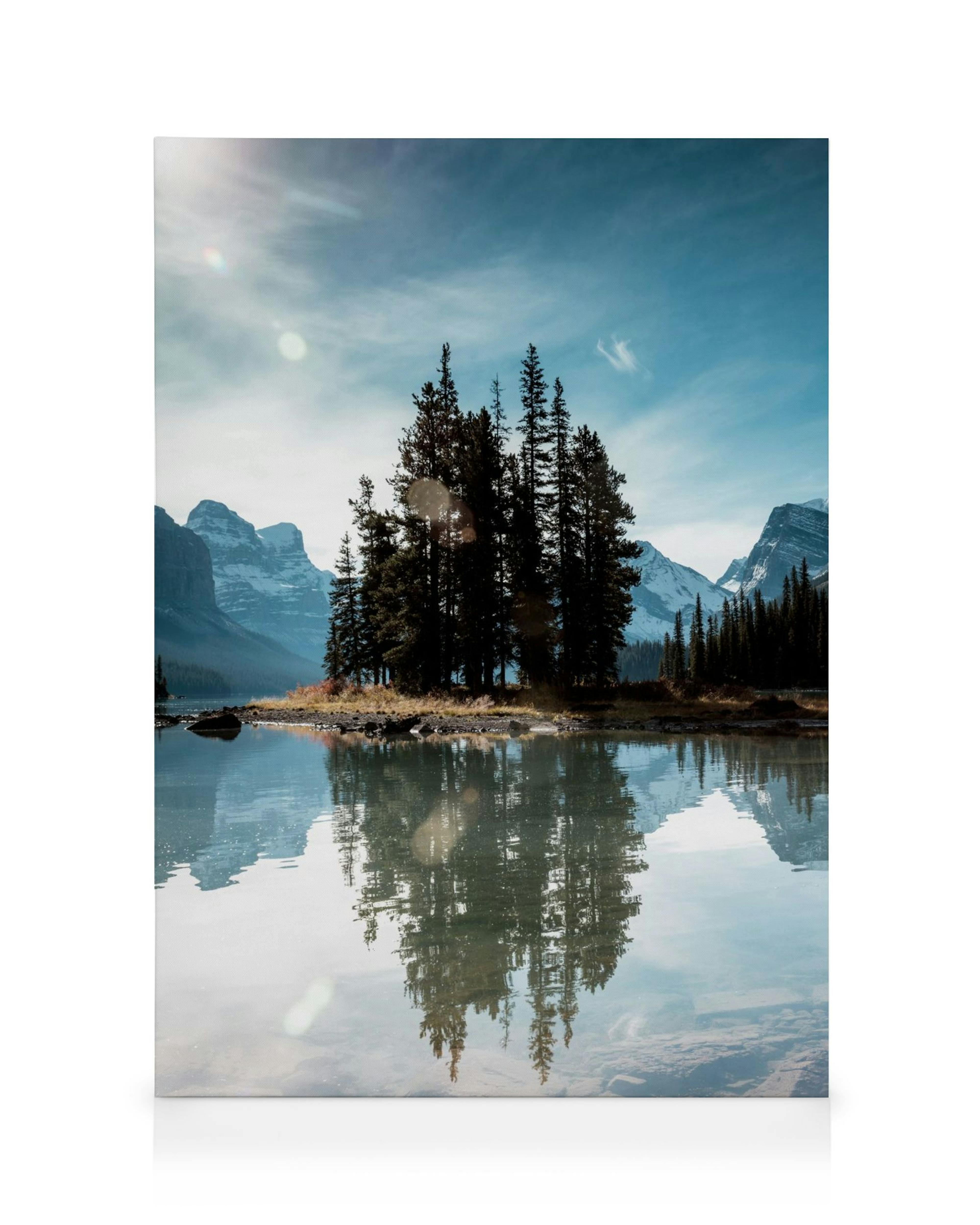 Spirit Island canvas print, a serene lake with an evergreen tree island reflecting on the calm water, snow-capped mountains and 