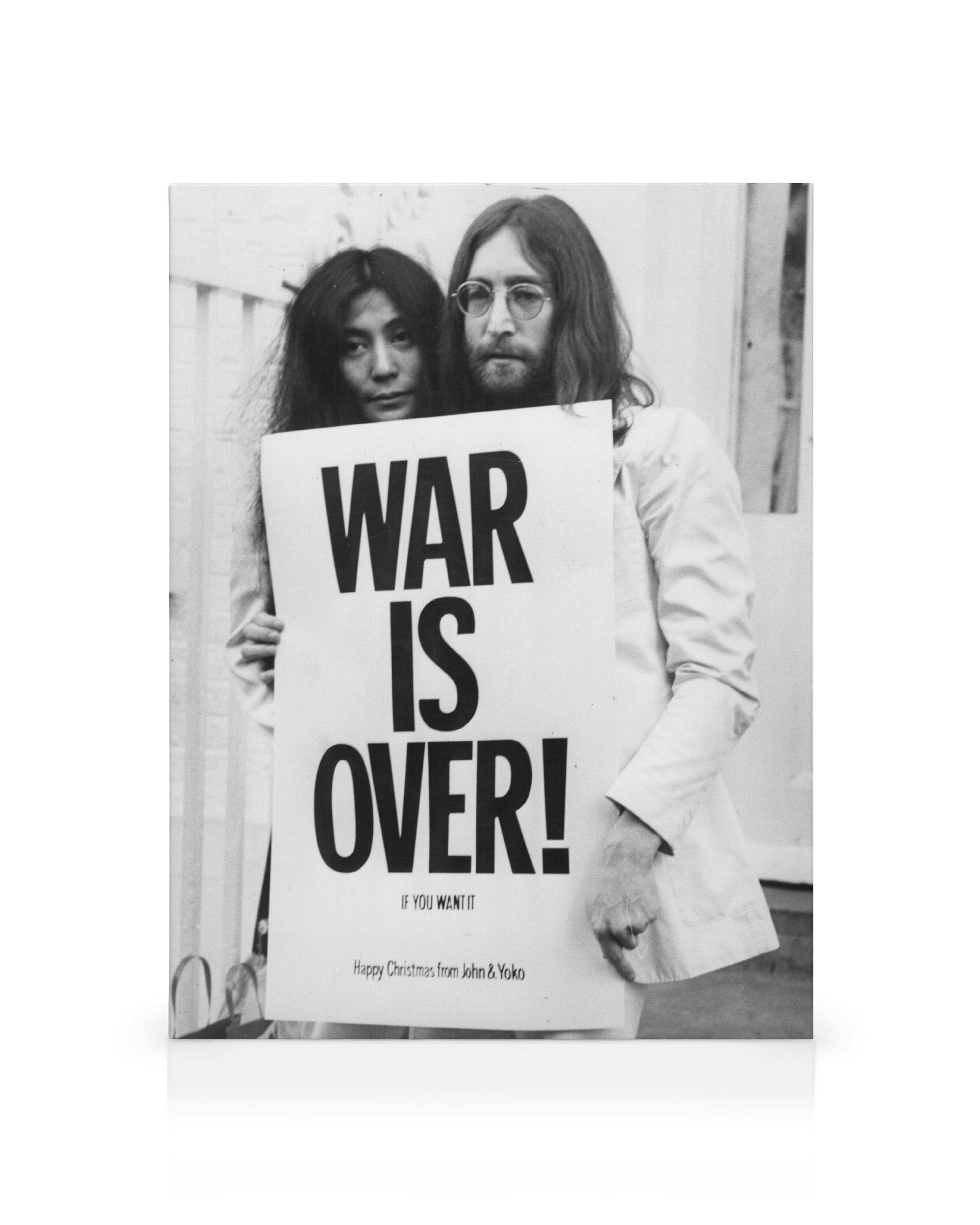 A black and white canvas print of John Lennon and Yoko Ono holding a WAR IS OVER! sign.
