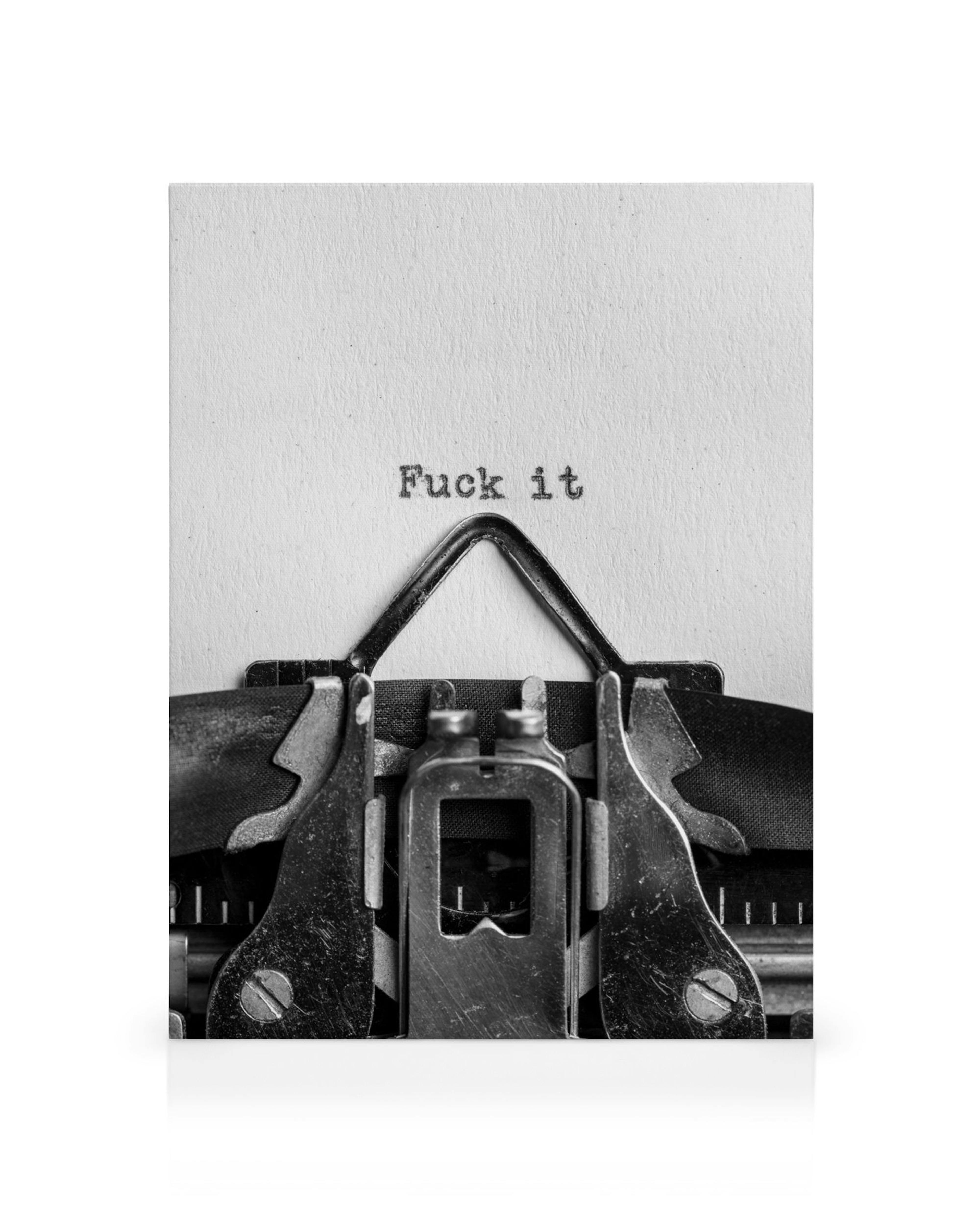 A monochromatic canvas print featuring a close-up of a typewriter with Fuck it typed on the paper.
