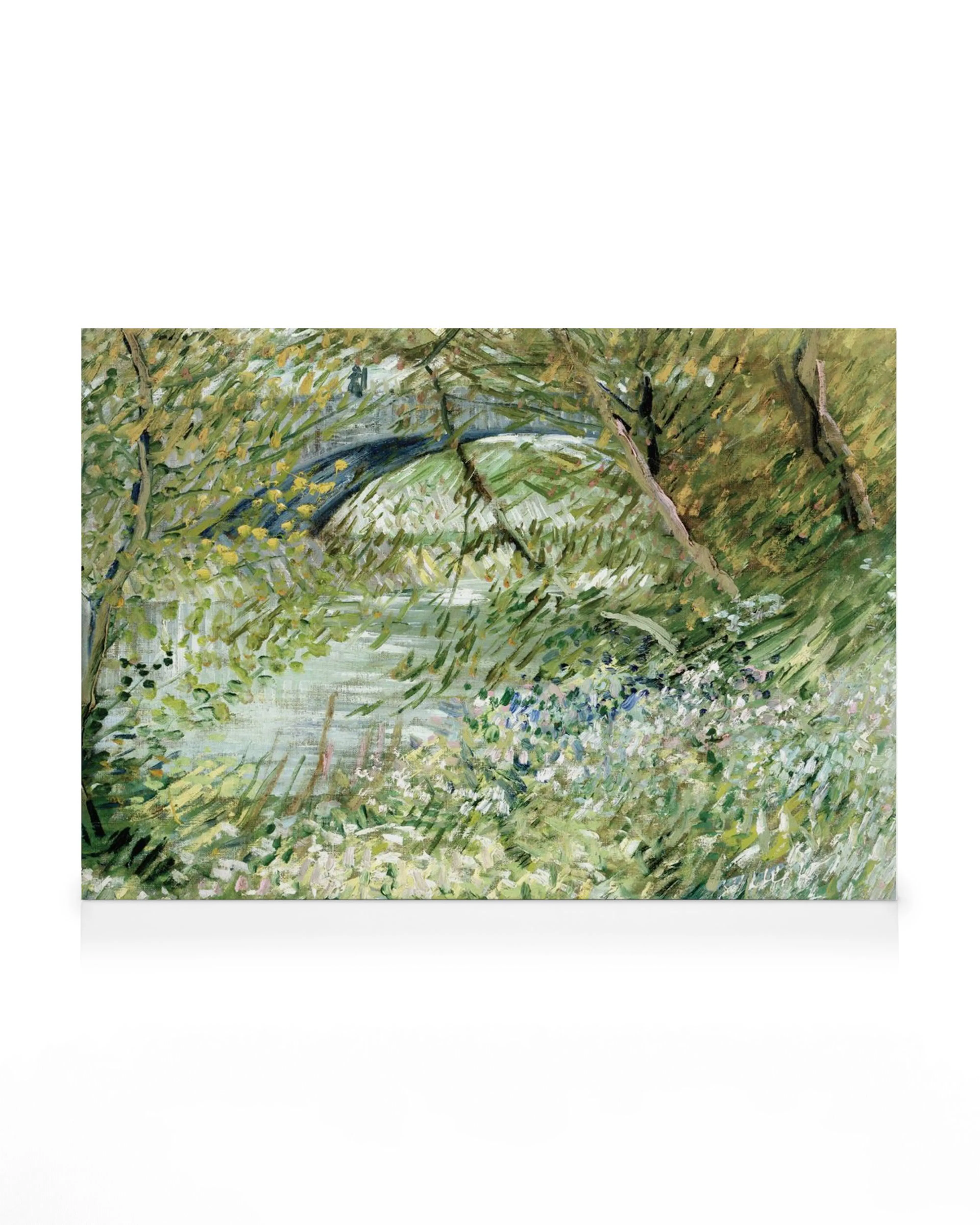 A canvas print of a lush impressionist landscape with a bridge over water, surrounded by green foliage and white flowers.