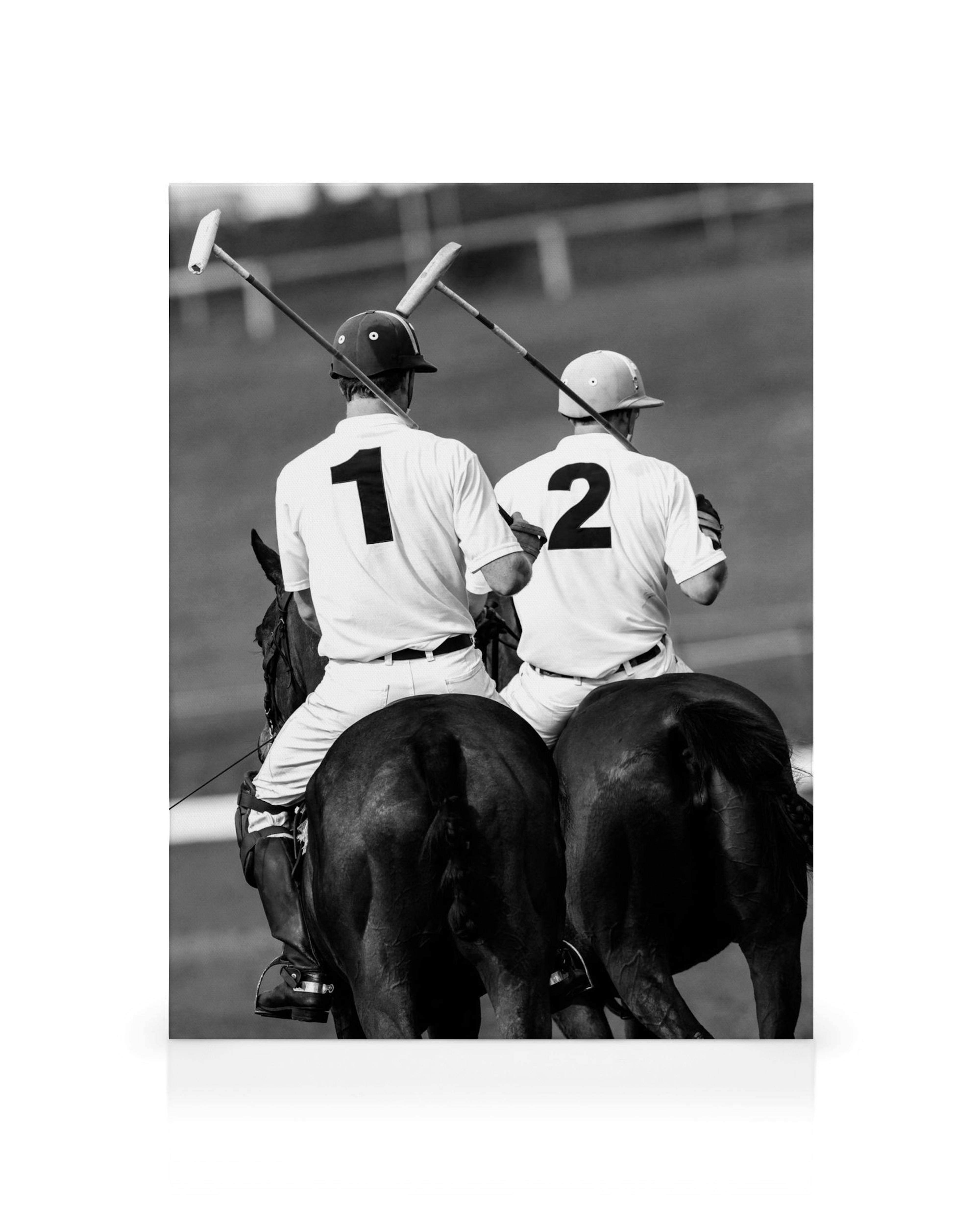 Black and white canvas print of two polo players on horseback, seen from behind, holding mallets.