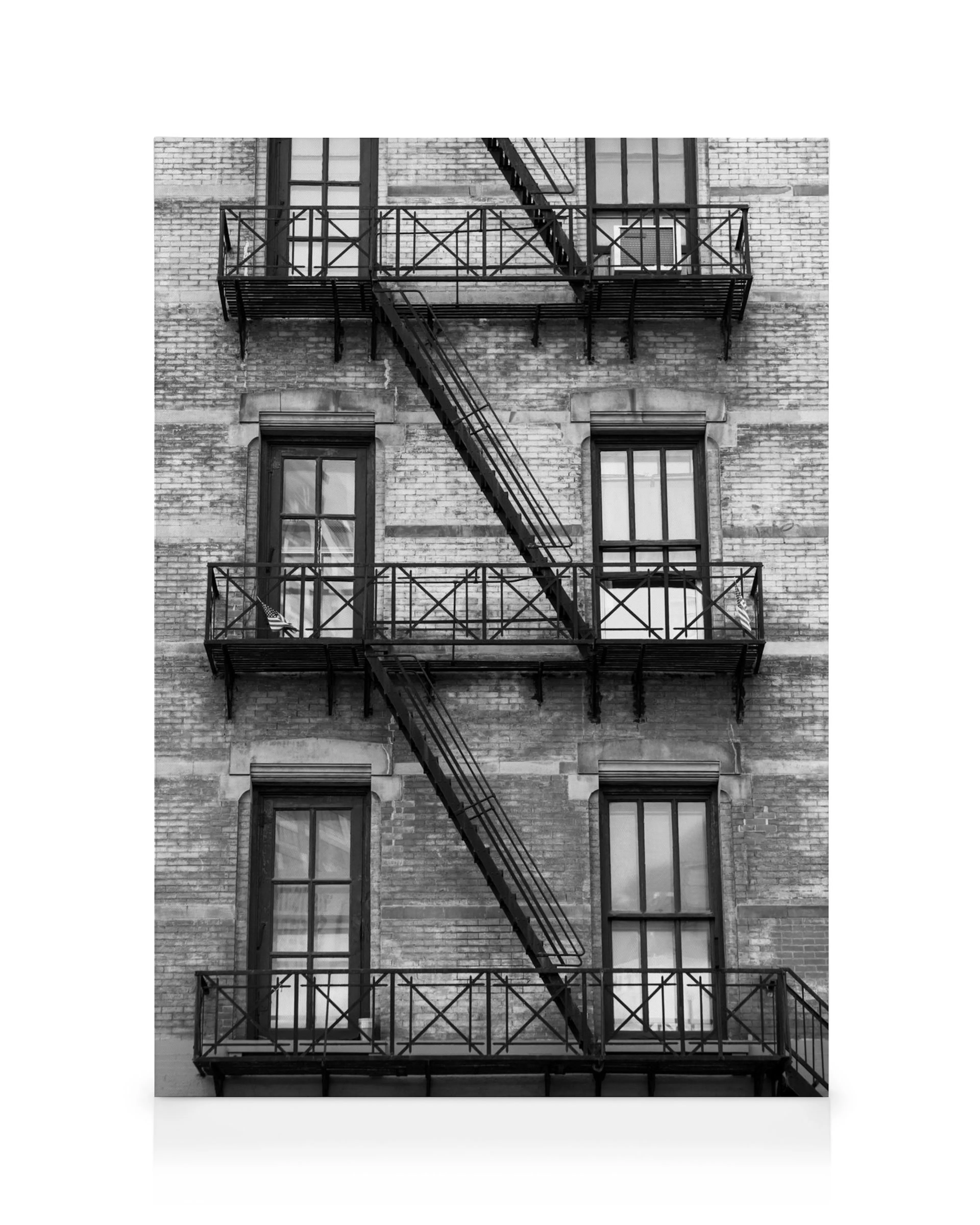 Black and white NY fire escape canvas print on a brick building, urban industrial wall decor