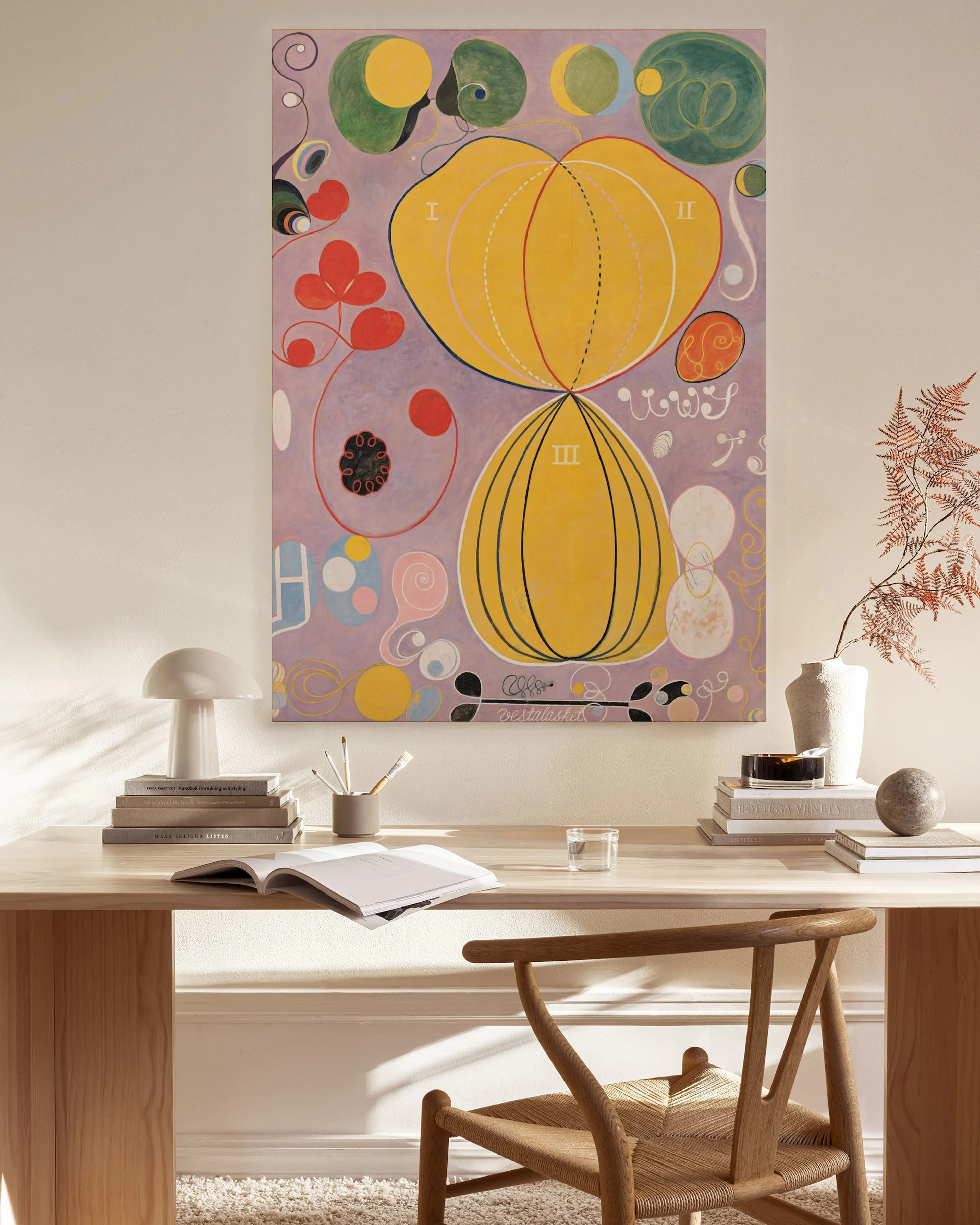 A canvas print of a vibrant abstract artwork with two large yellow bulbous shapes, on a light purple background with red and gre