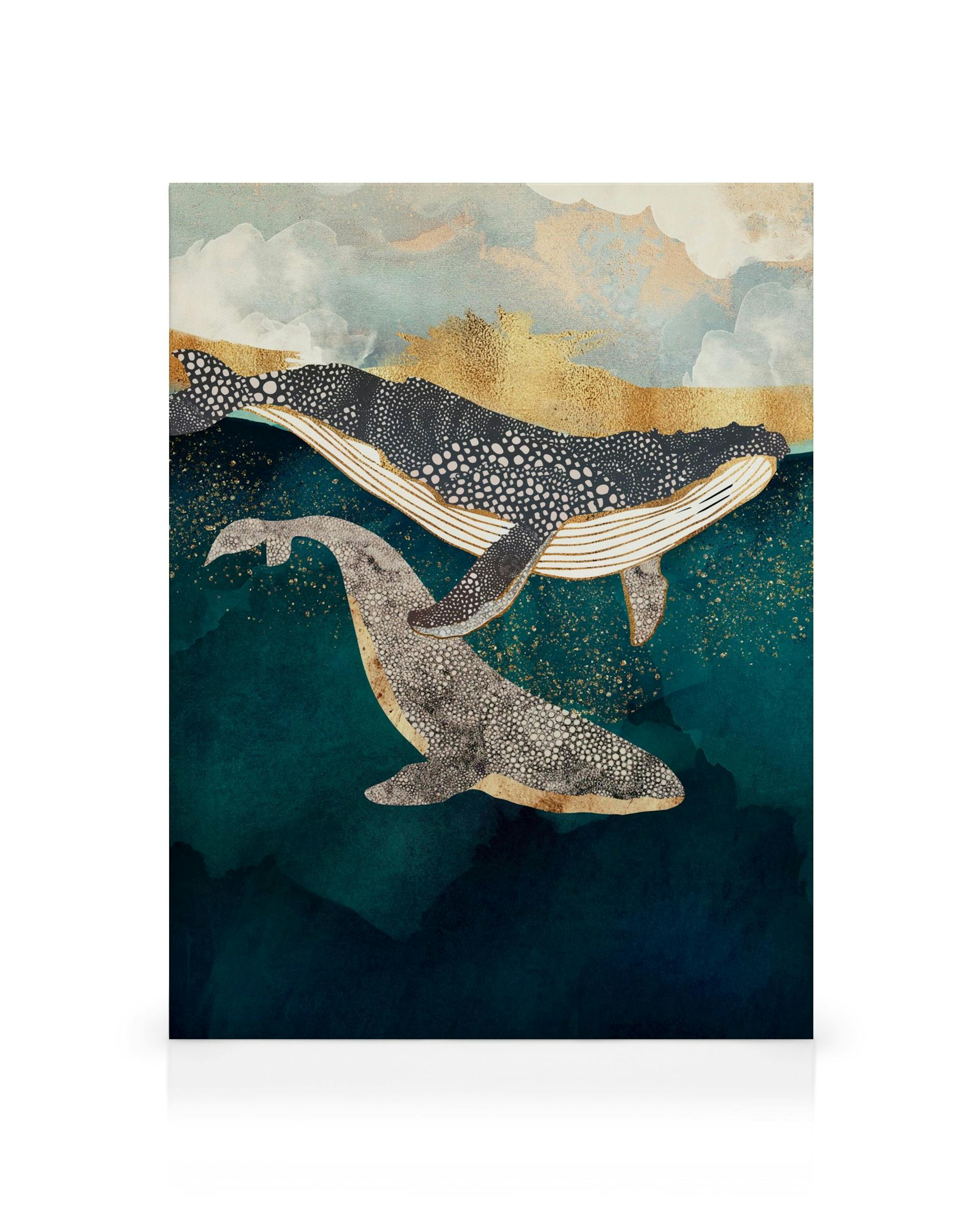 Canvas print with two patterned whales swimming in a blue sea, under a golden sky with white clouds.