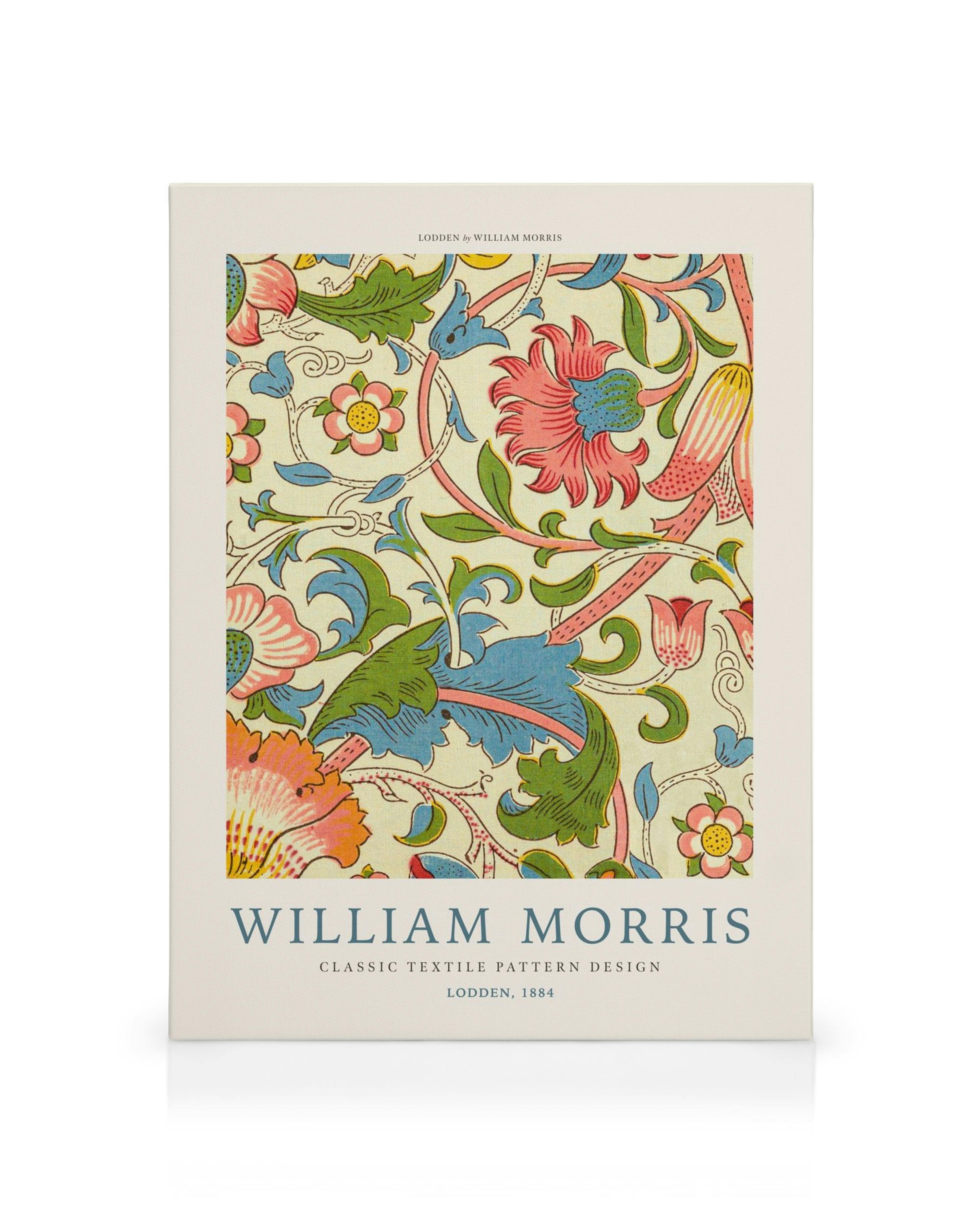 William Morris Lodden canvas met rode, blauwe, groene en gele bloemen, bladeren en stengels op een gebroken witte achtergrond.
