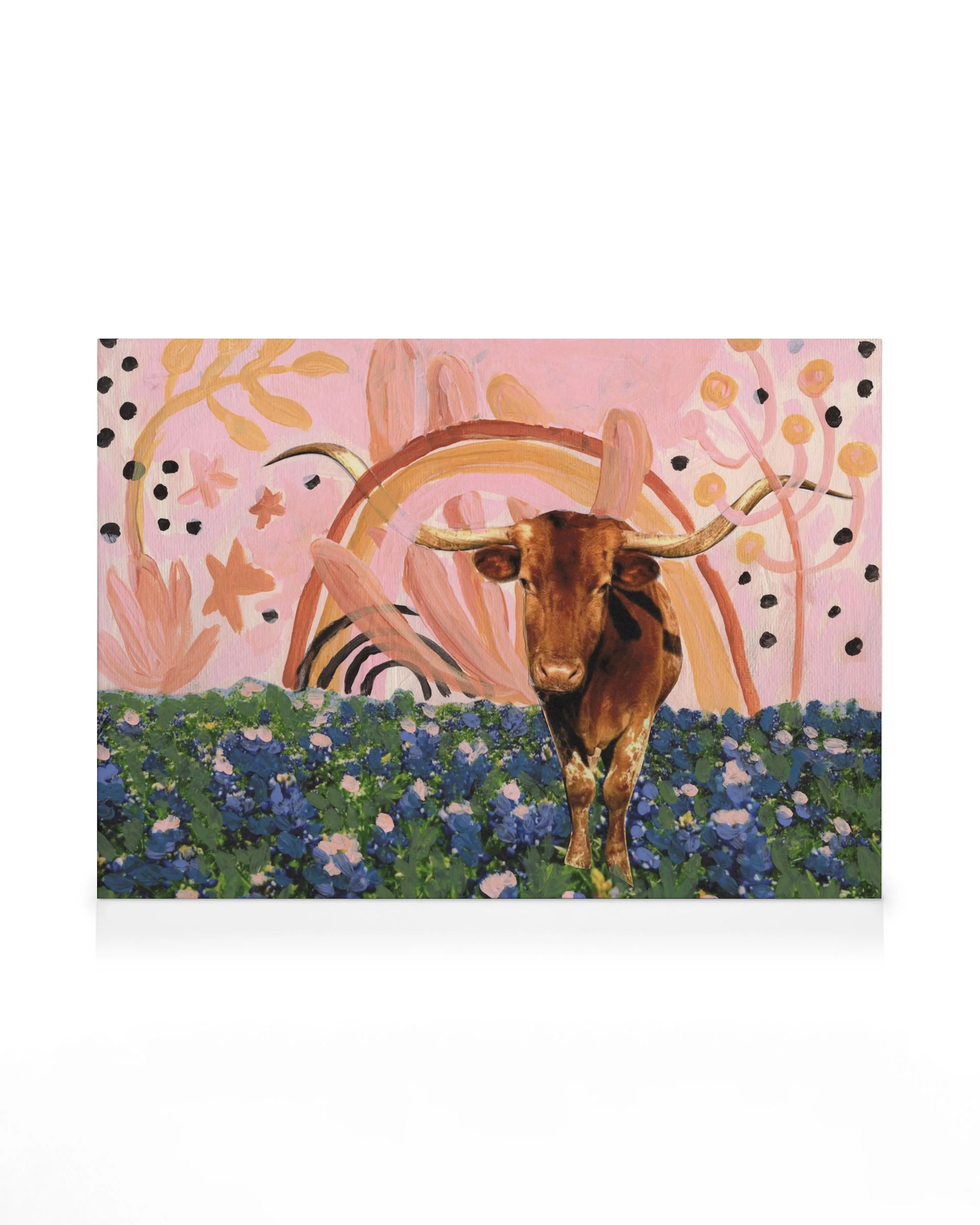 Rainbow Longhorns canvas print: Brown longhorn cow in a blue flower field with pink floral patterns, dots, and a rainbow.