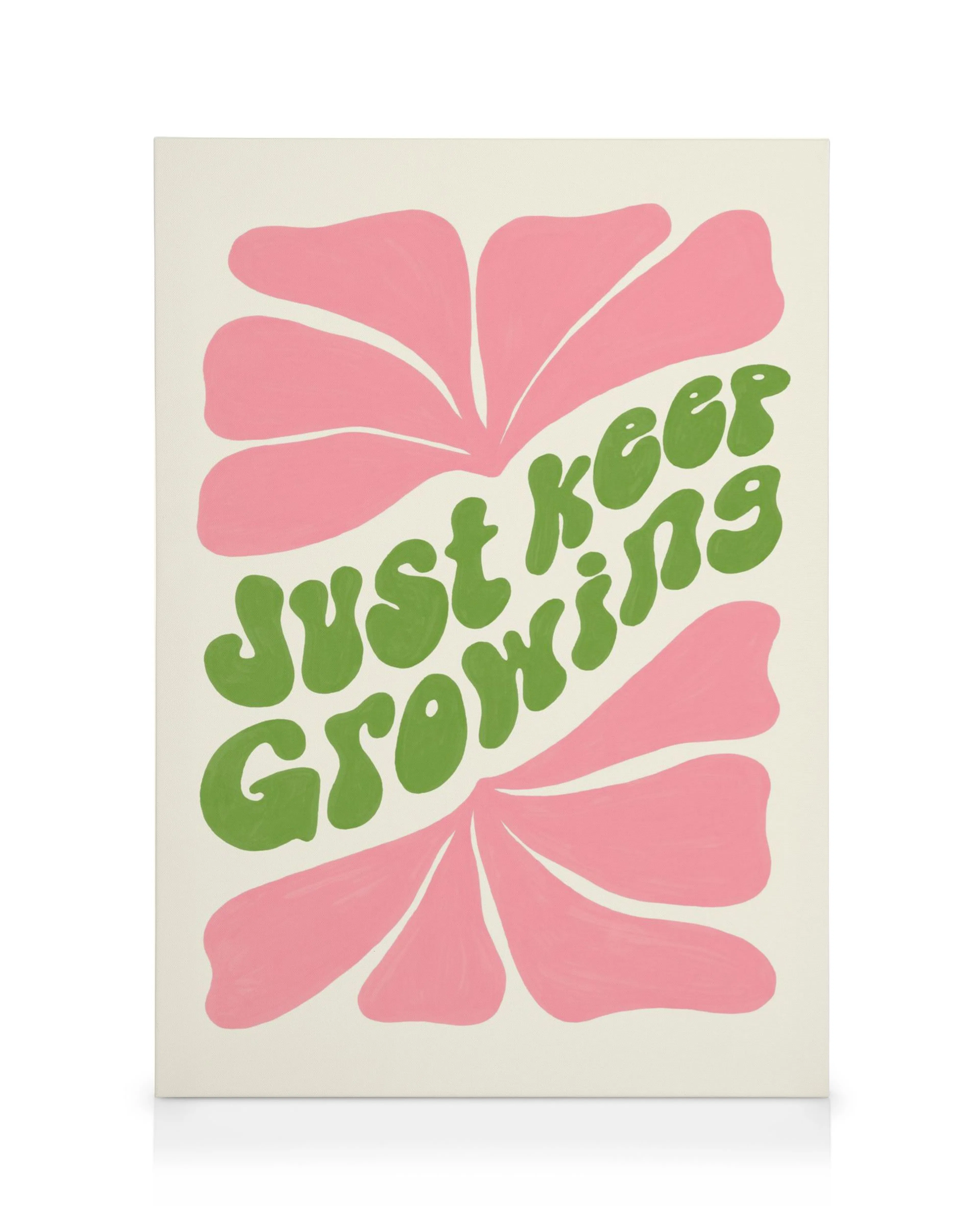 Botanical canvas print with a pink flower design and Just Keep Growing in green text on a white background.
