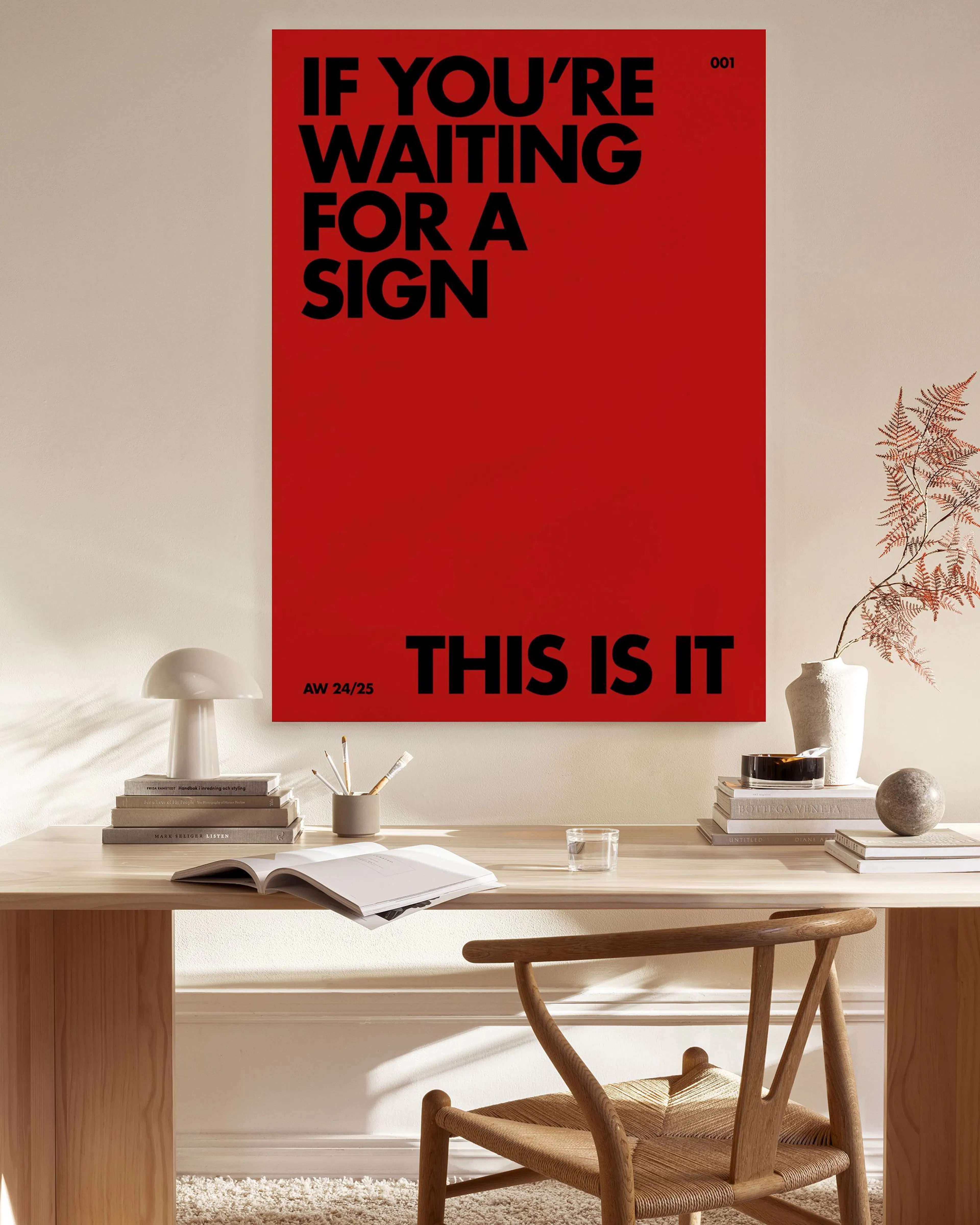 Rotes Leinwandbild mit schwarzem Text IF YOU’RE WAITING FOR A SIGN THIS IS IT“ und Details 001“ und AW 24/25“.