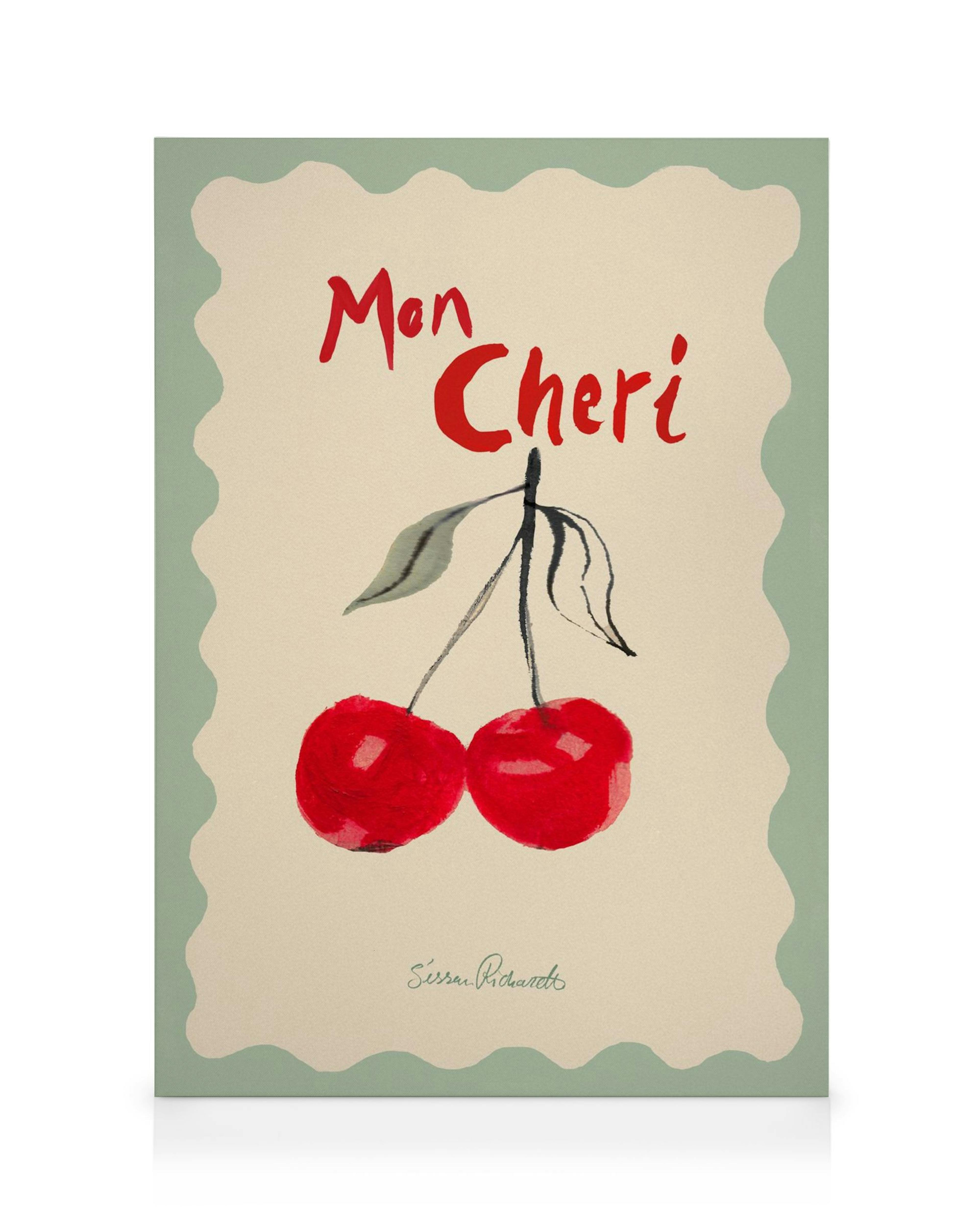 Stampa su tela con due ciliegie rosse e scritta Mon Cheri su sfondo beige con bordo verde ondulato.