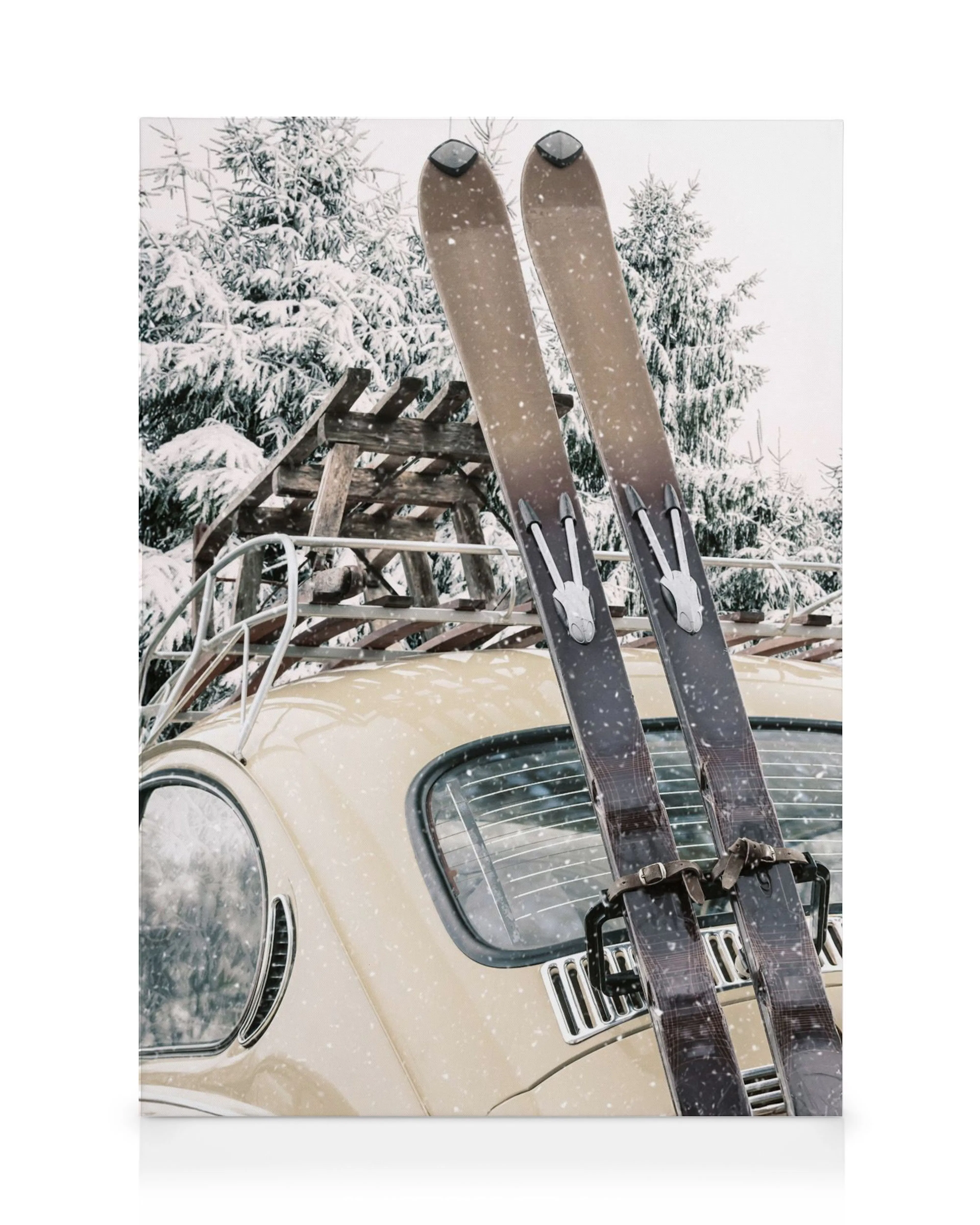 A canvas print of a vintage beige car with skis on a roof rack, parked in a snowy forest scene.