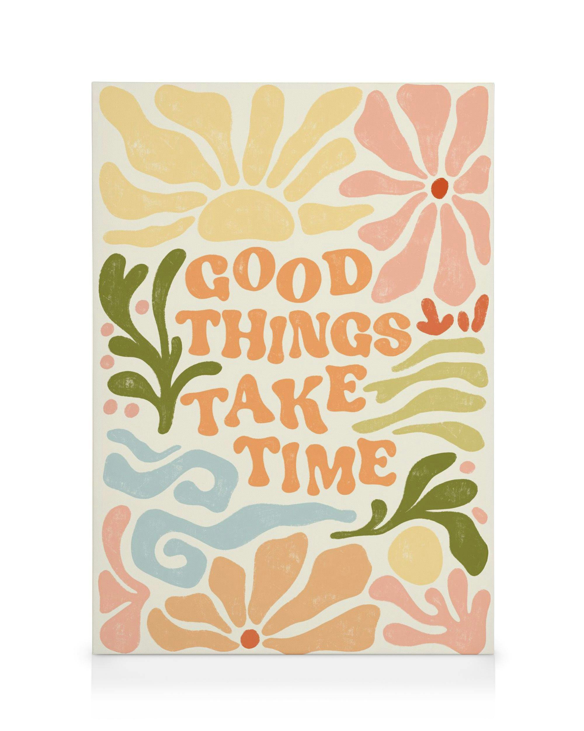 Une toile avec le texte GOOD THINGS TAKE TIME entouré de motifs floraux et végétaux colorés.