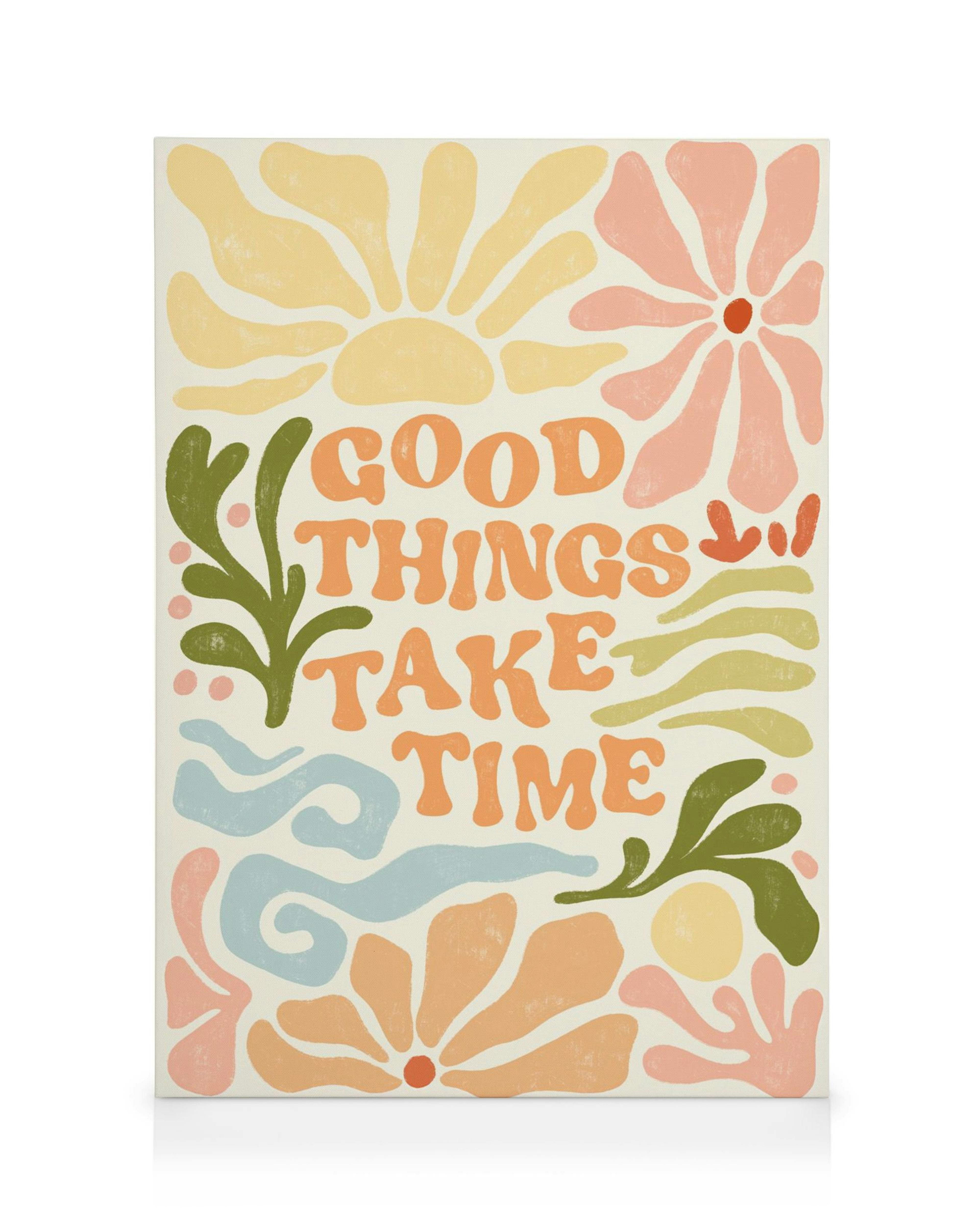 Une toile avec le texte GOOD THINGS TAKE TIME entouré de motifs floraux et végétaux colorés.