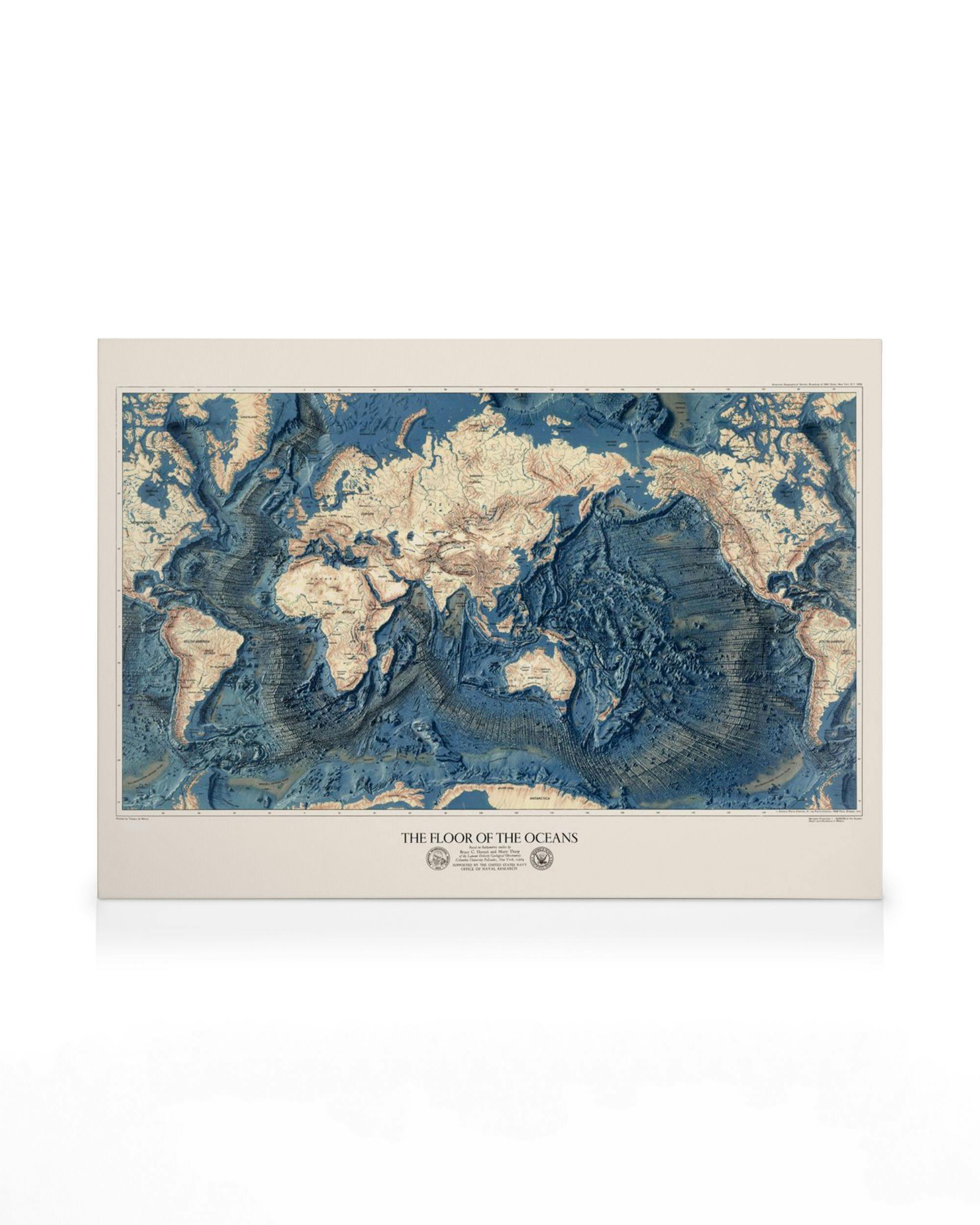 Ocean floor map canvas art with beige landmasses and blue oceans, showing detailed bathymetric textures.