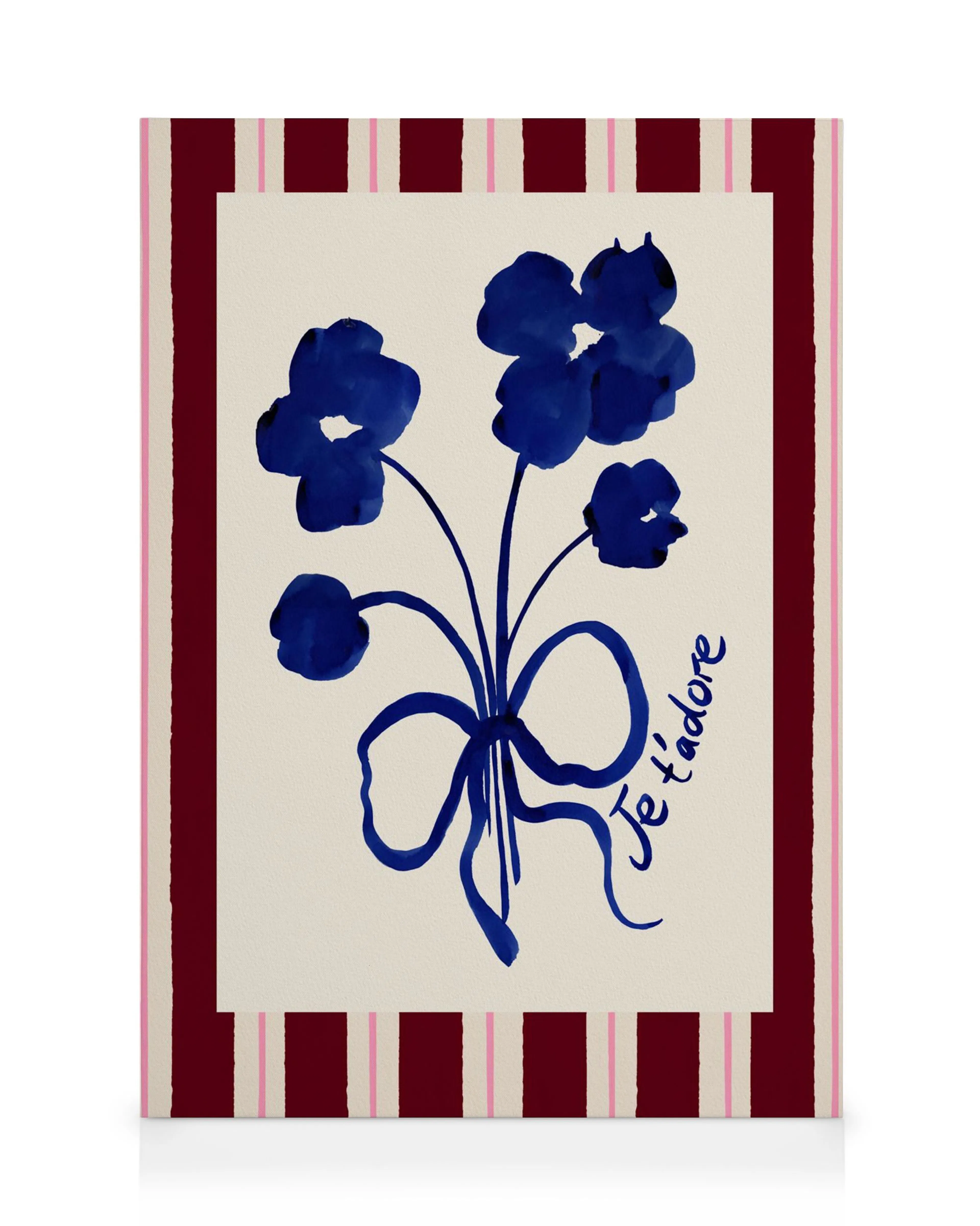 A canvas print with a dark blue watercolor bouquet of flowers and a bow, with Je tadore in script.