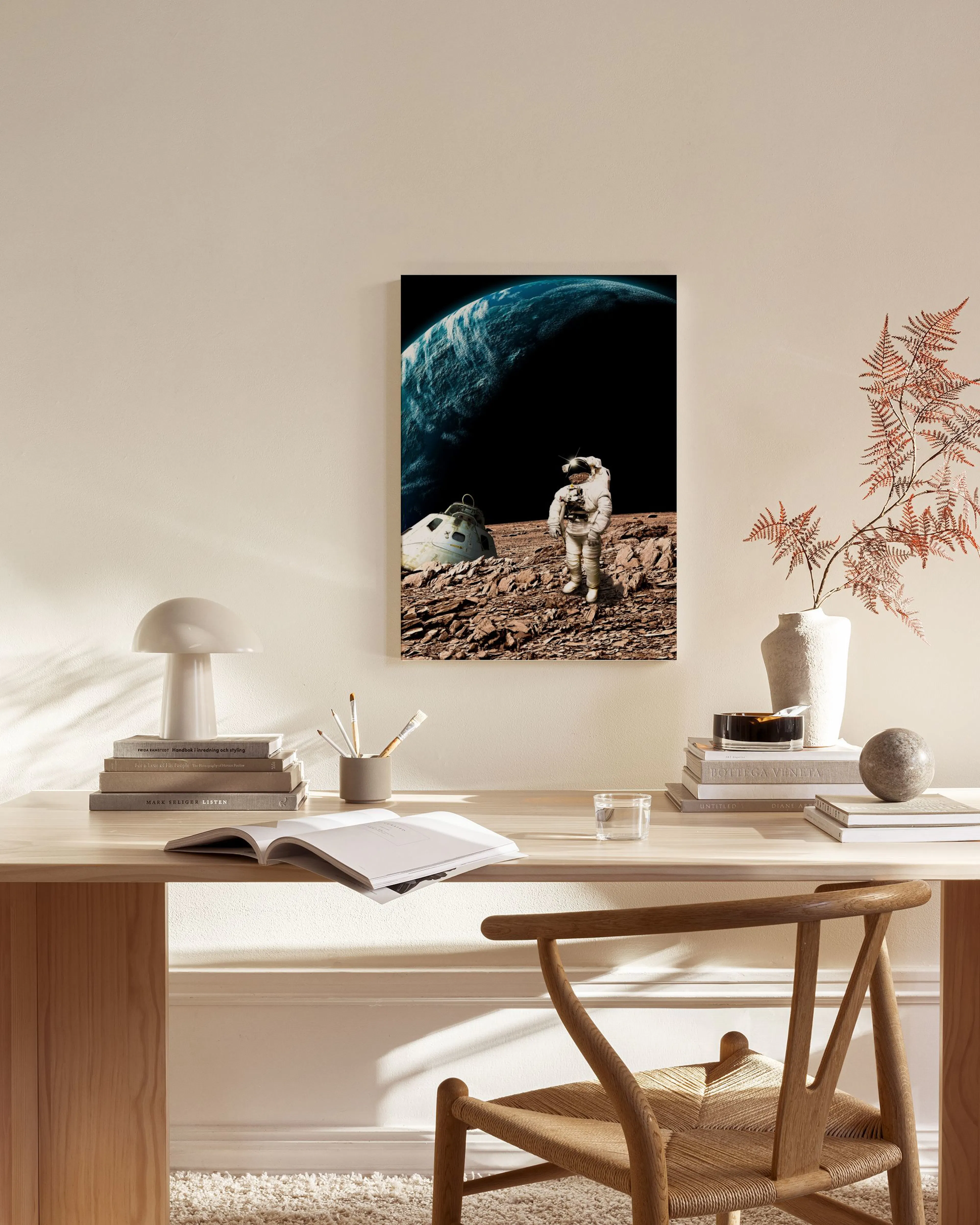 Astronaut on a rocky red planet with a large blue planet and black space in the background, displayed in a minimal living room.