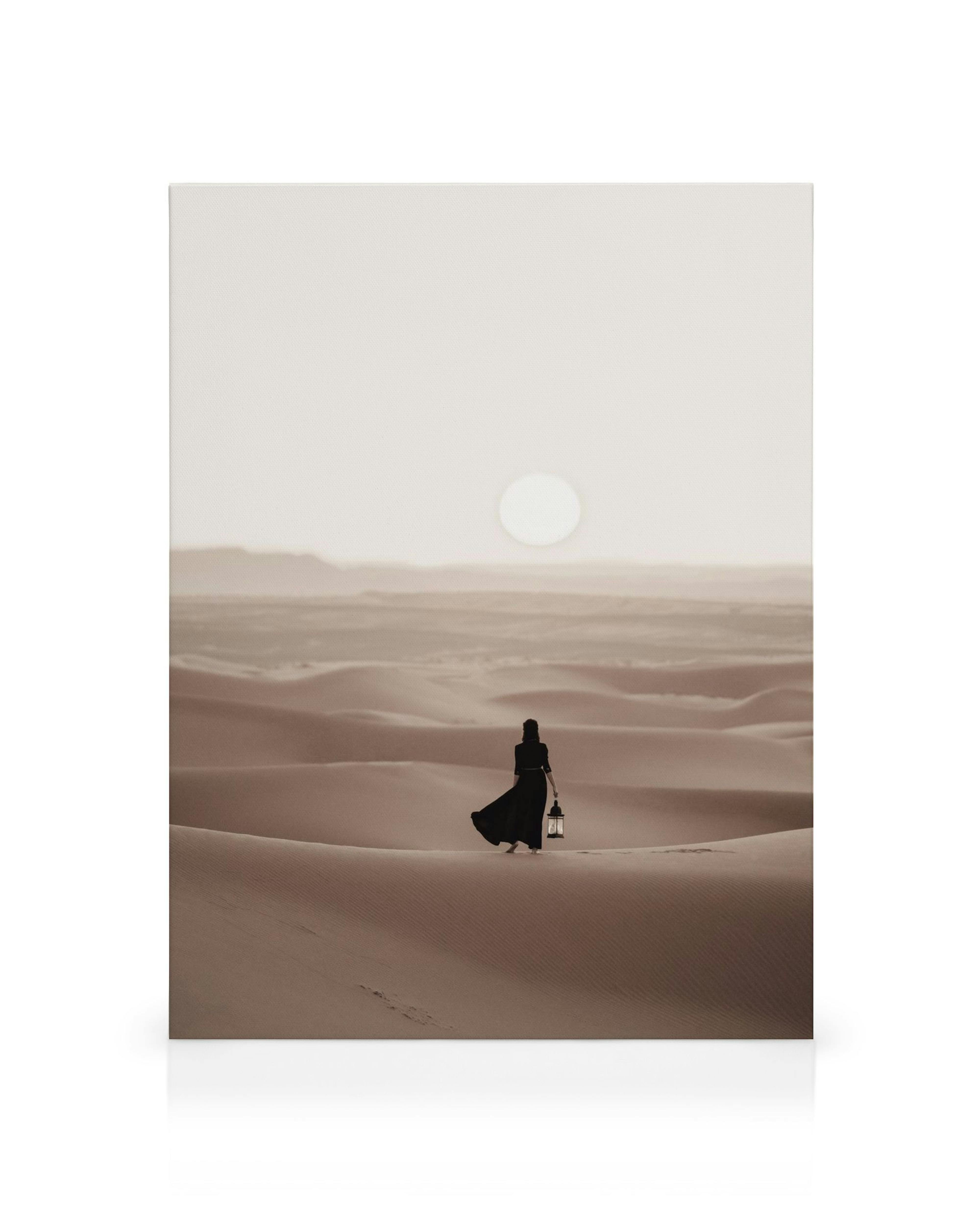 Woman in desert landscape canvas print, serene scene with a figure holding a lantern on a sand dune under a bright sun.