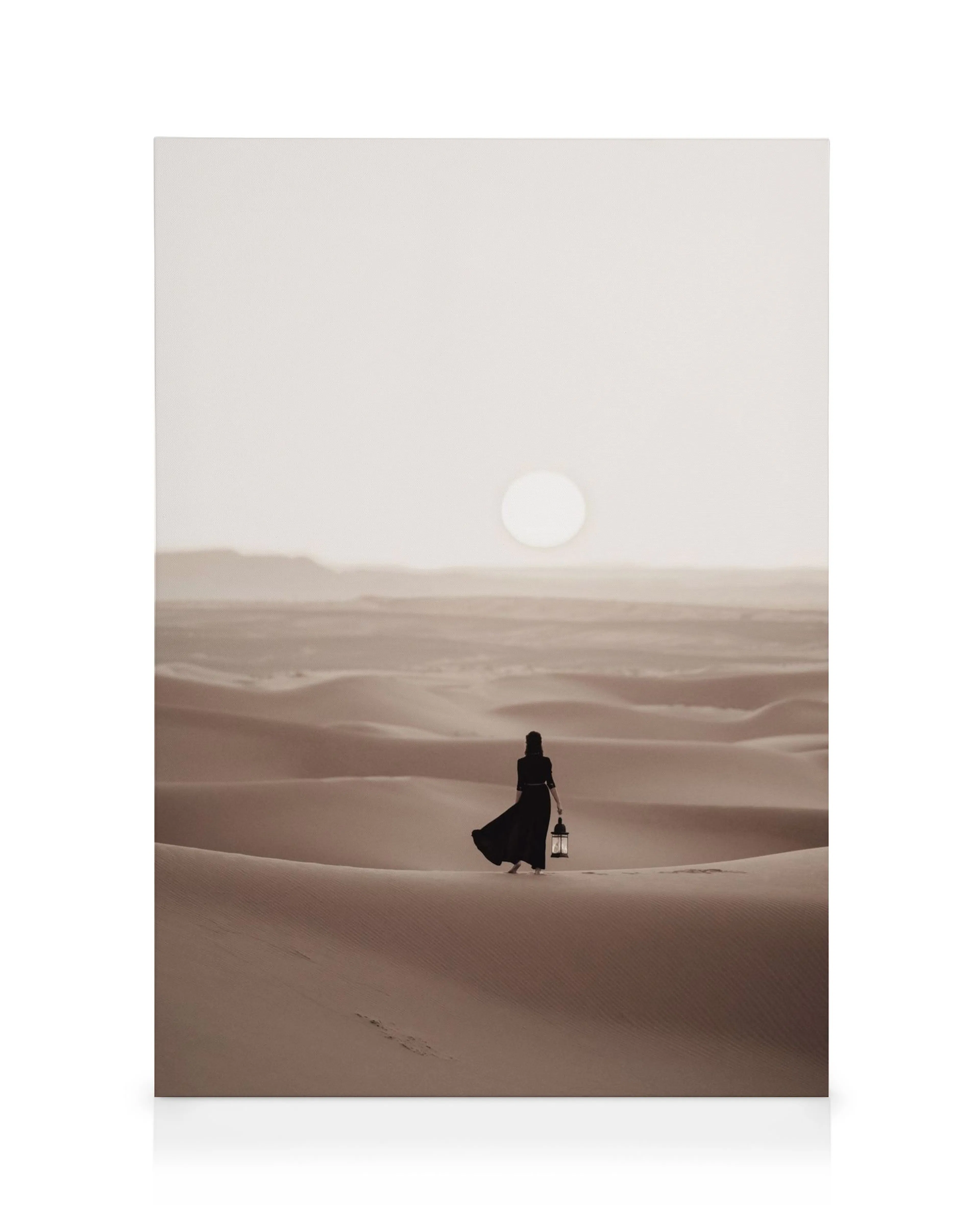 Desert landscape canvas, sepia toned with a woman in a black dress holding a lantern, walking across sand dunes under a full moo