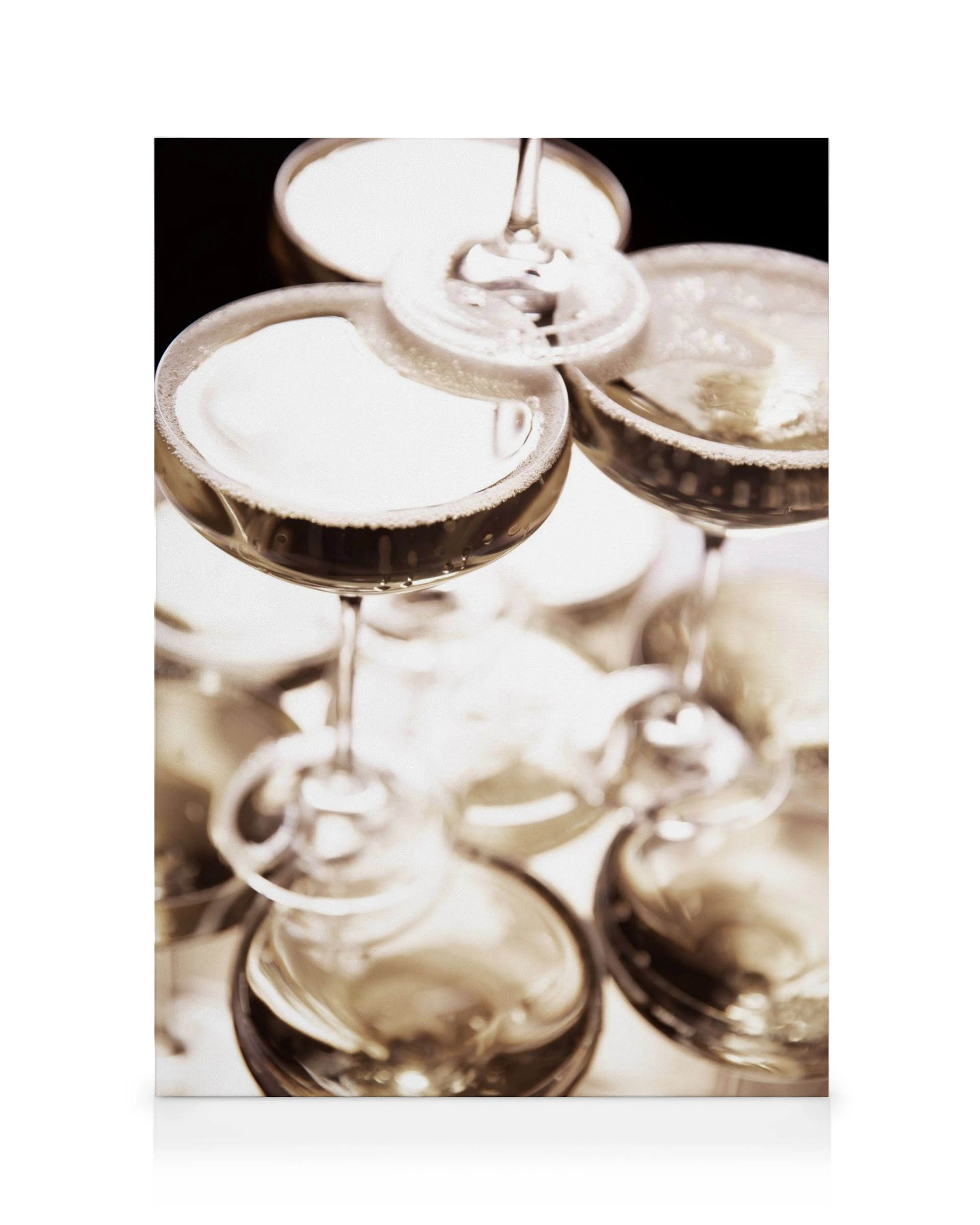 A champagne tower of coupes with sparkling bubbly, golden liquid, and effervescent foam, creating a festive celebration scene.
