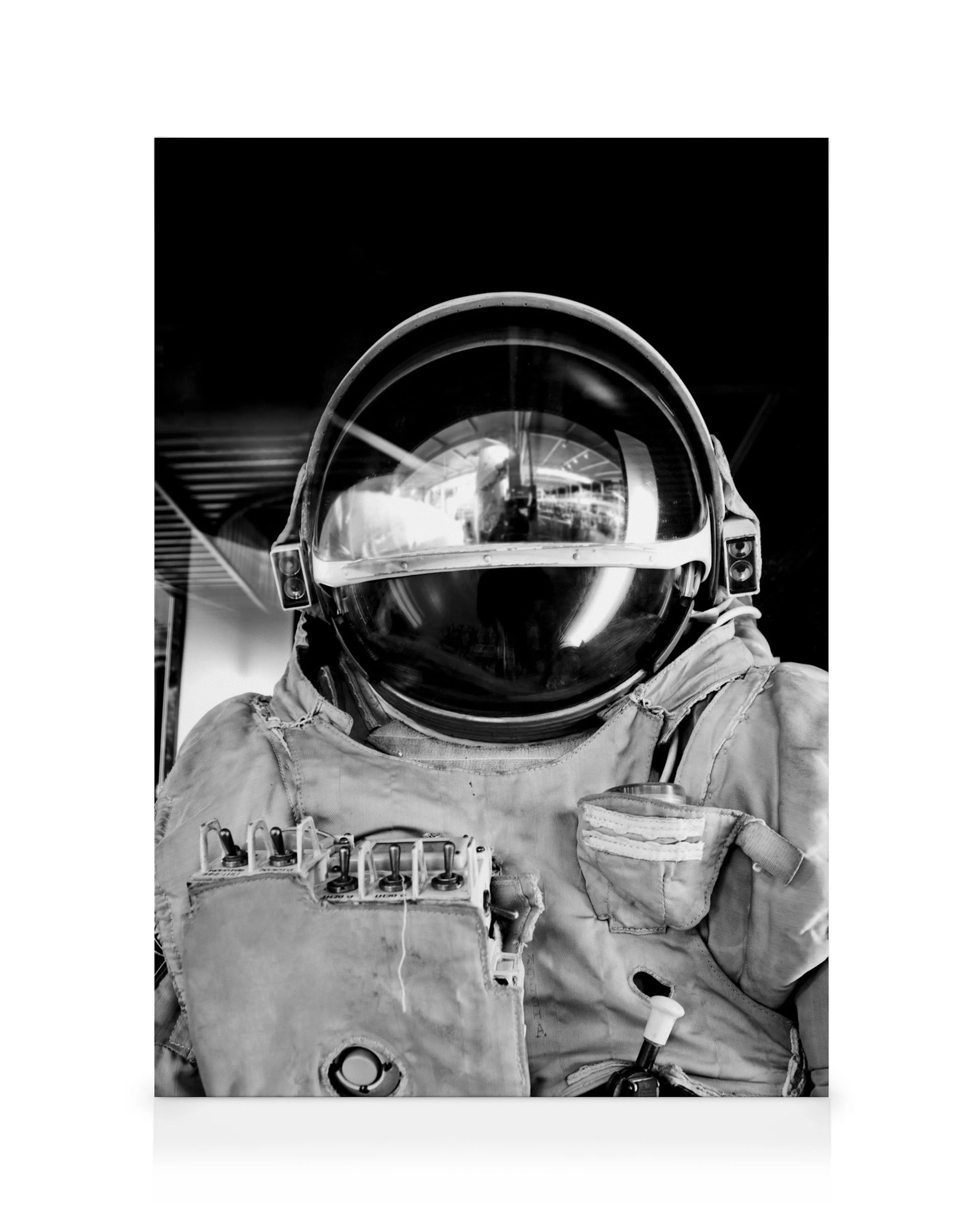 Black and white astronaut in reflective spacesuit with large helmet, detailed with pockets and hoses. Space wall art.