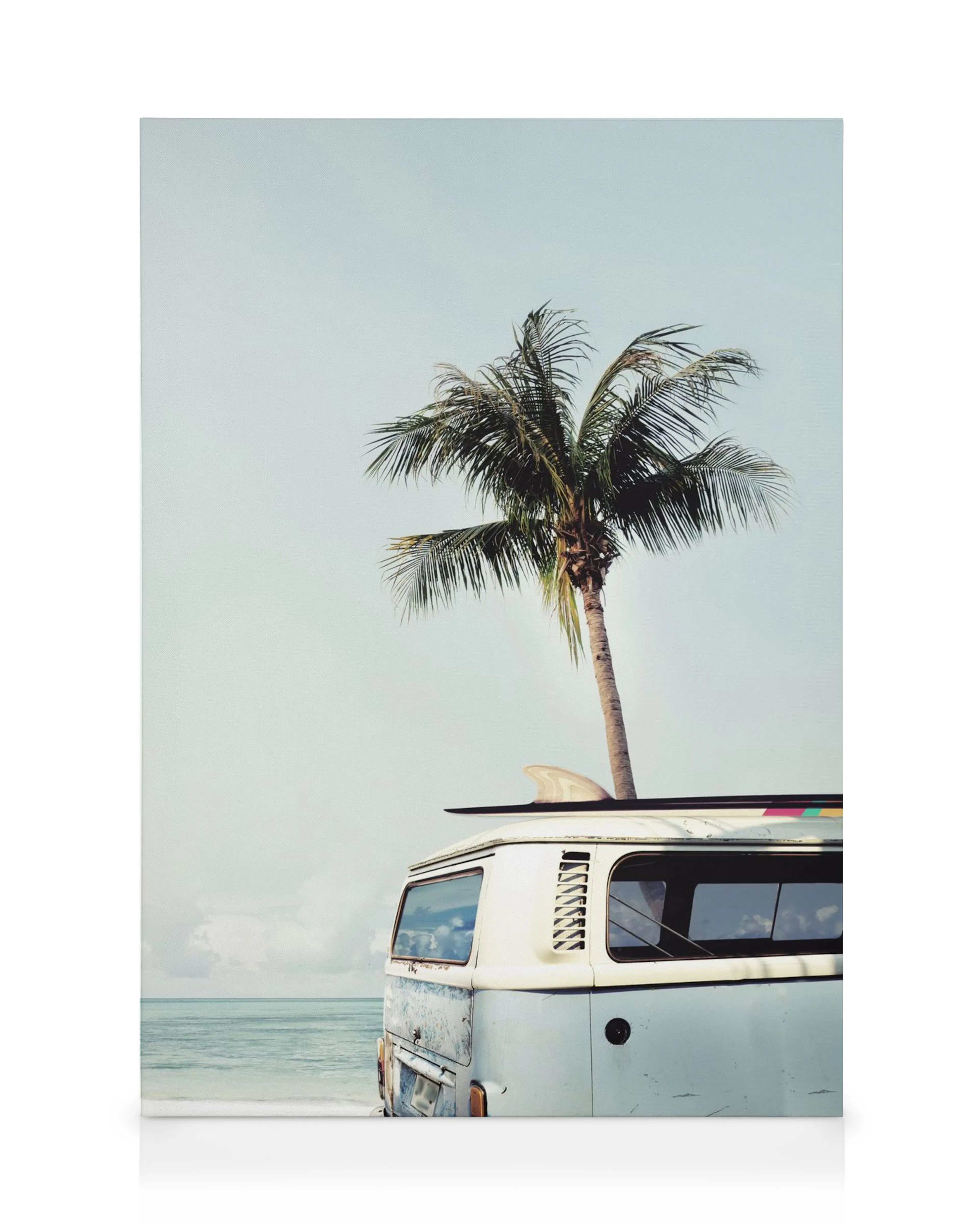 Lienzo de furgoneta azul y blanca con tabla de surf en la playa, palmera y océano.