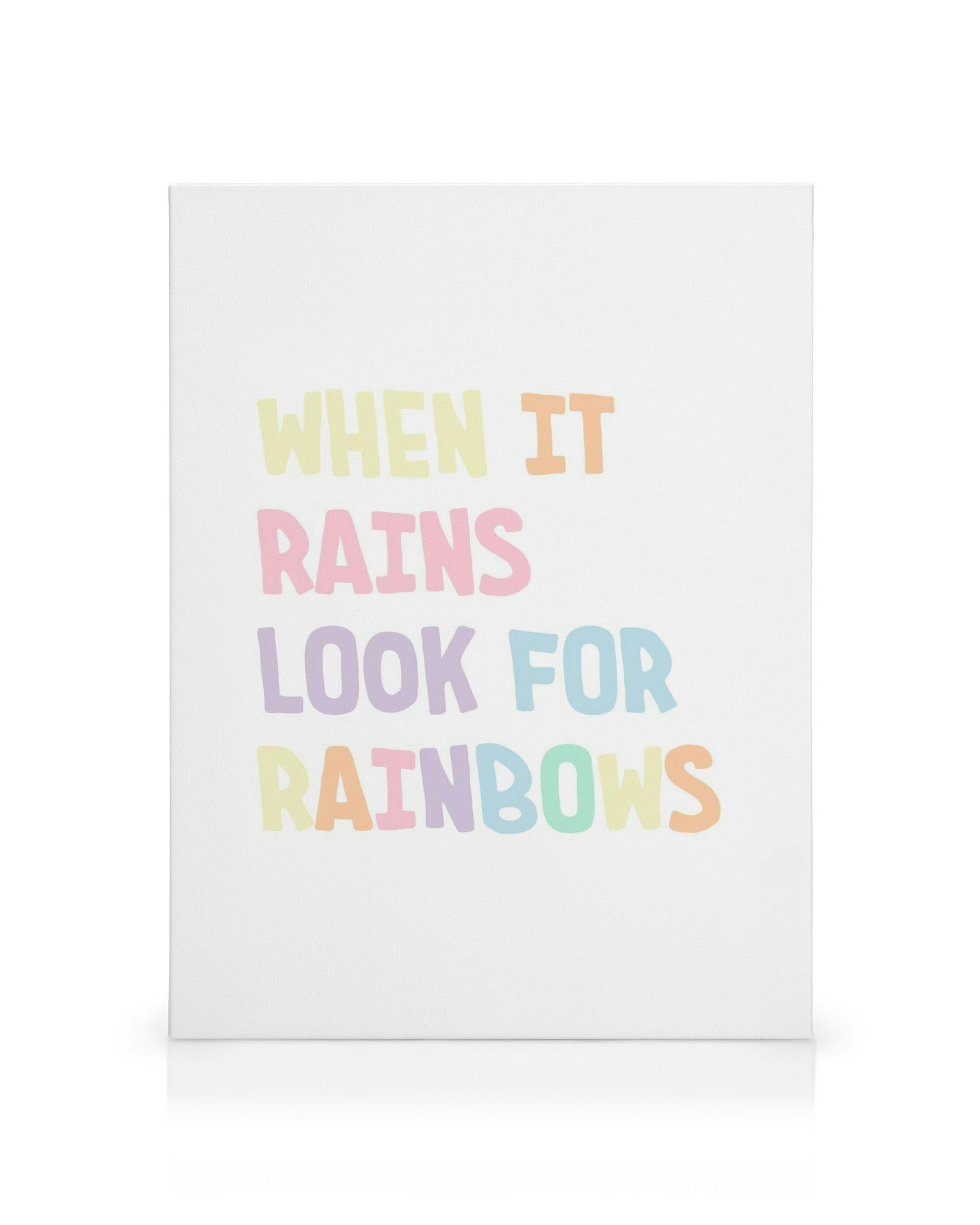 White canvas print with When It Rains Look For Rainbows in pastel coloured, rounded letters. Nursery wall art.