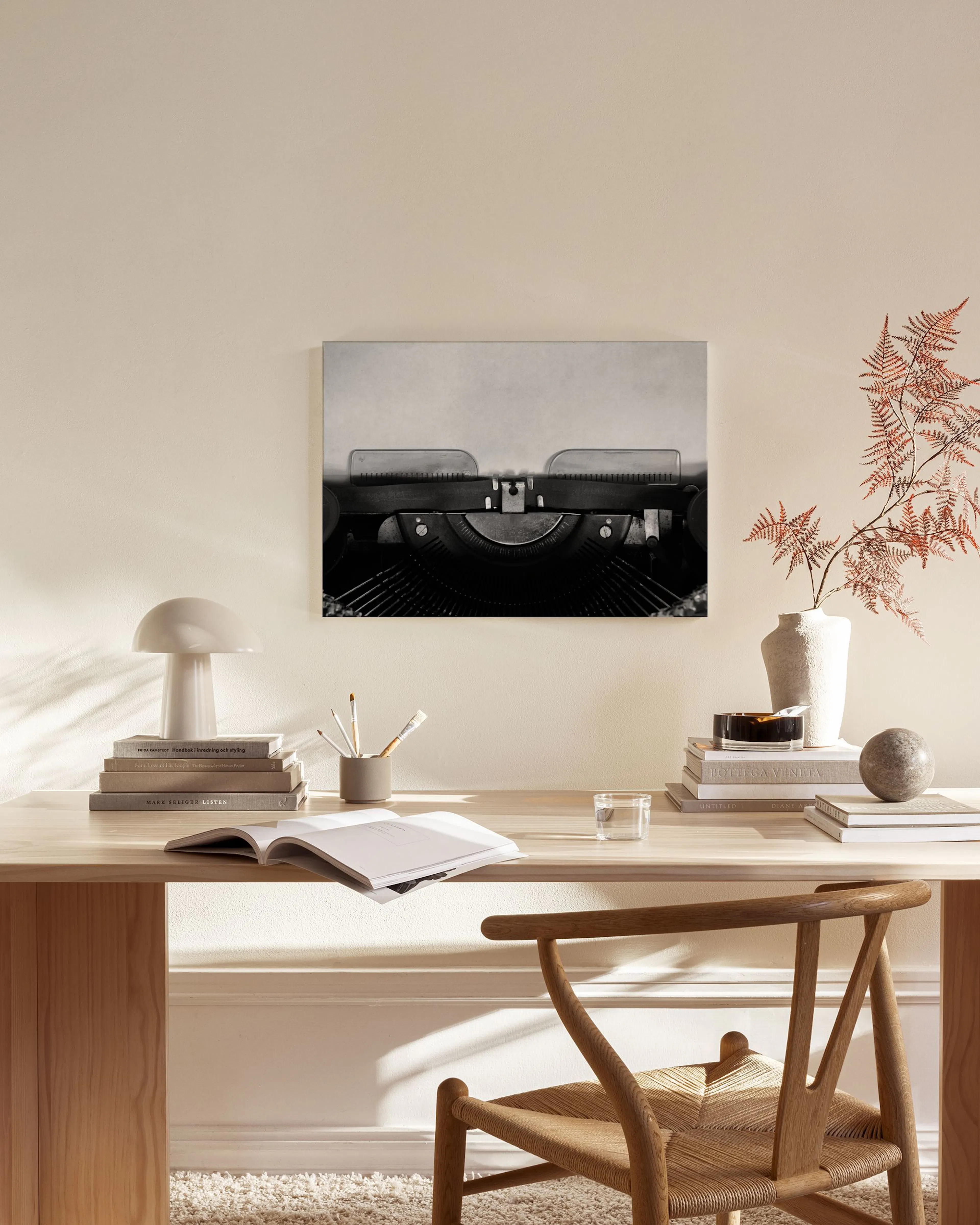 A black and white canvas print of a vintage typewriter with a sheet of paper.