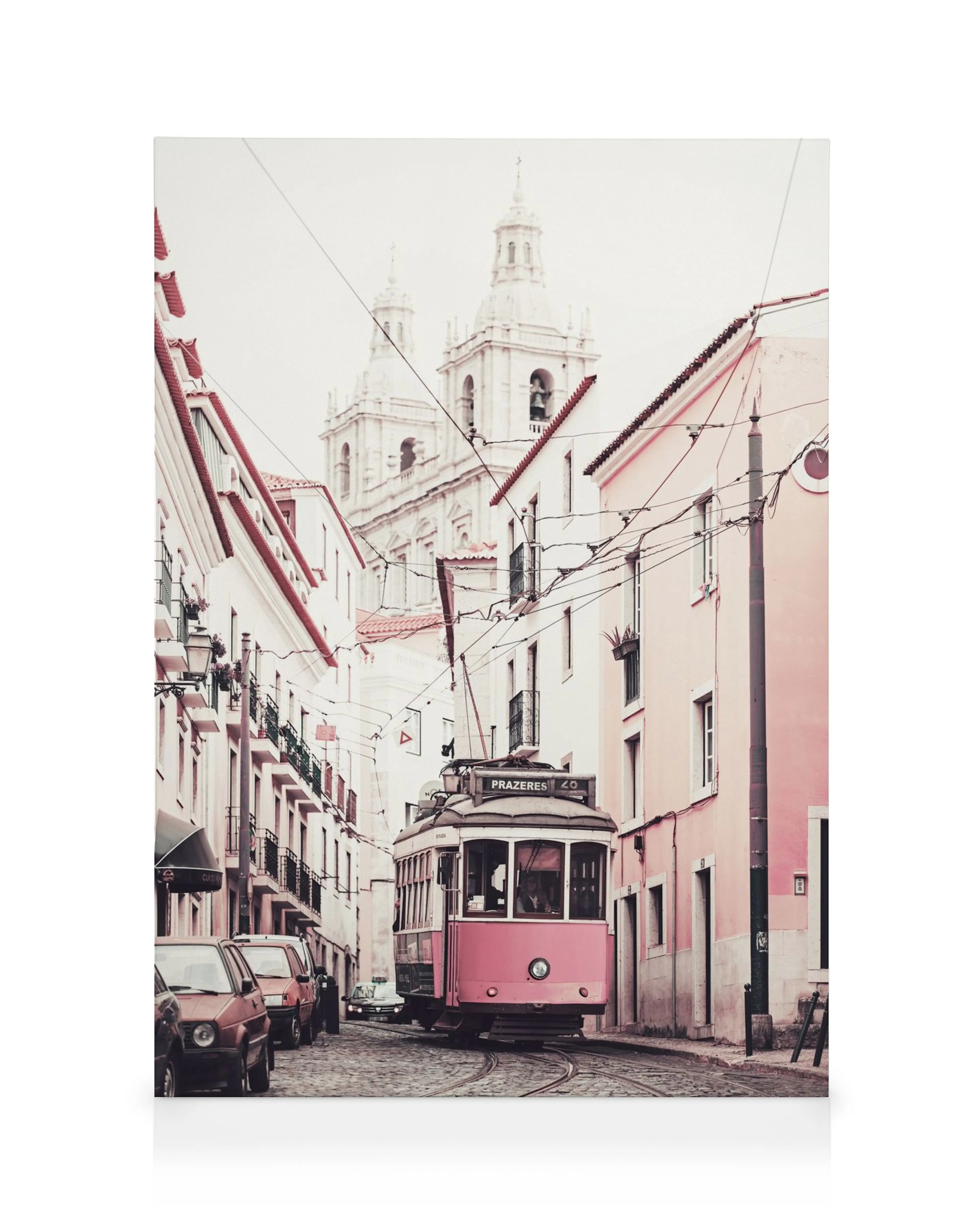 Pink tram on cobblestone street with historic buildings and church in background, travel canvas print.